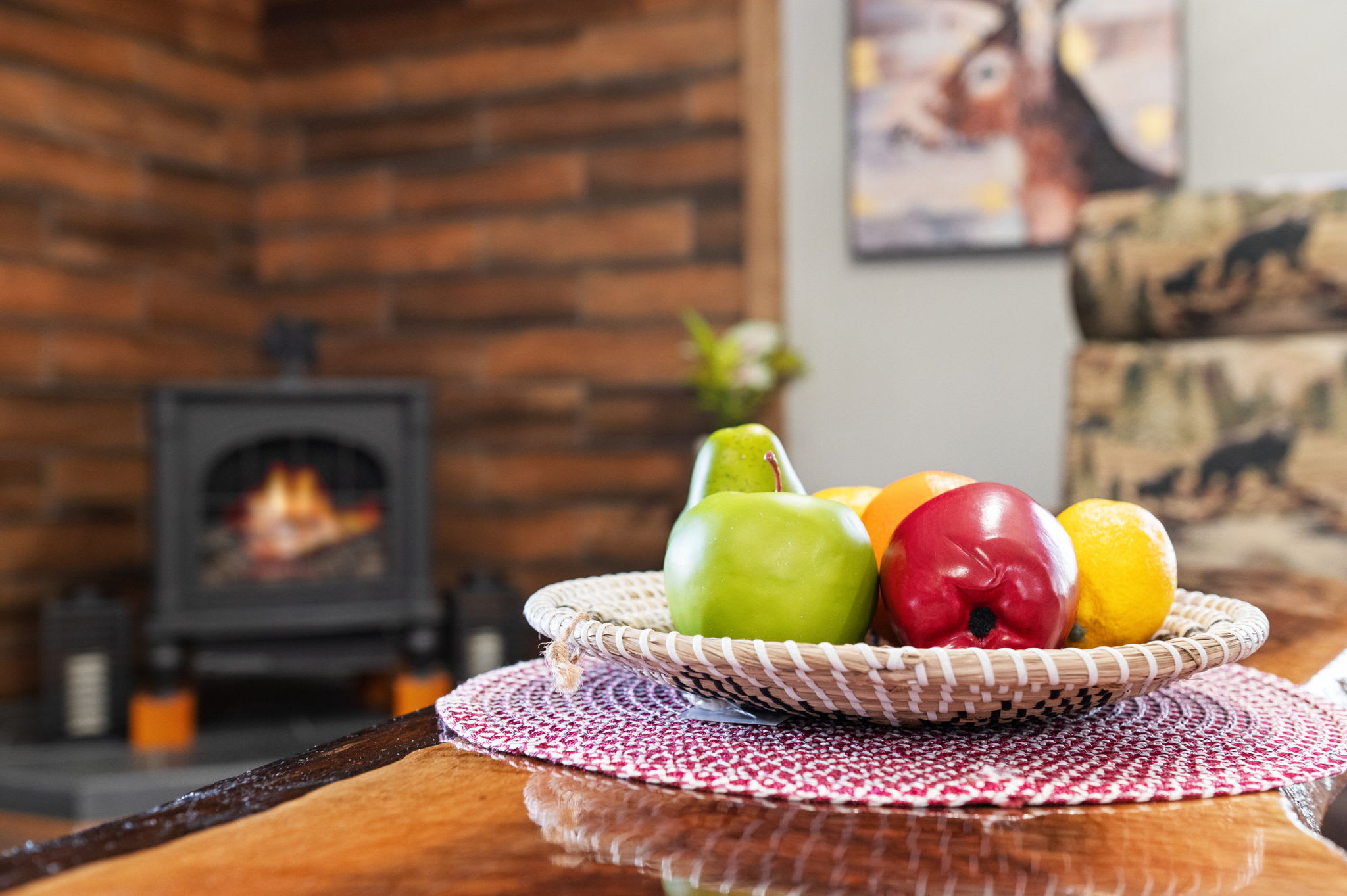 A bright display of colorful fruit adds a welcoming touch, hinting at the warmth of this cozy living space.