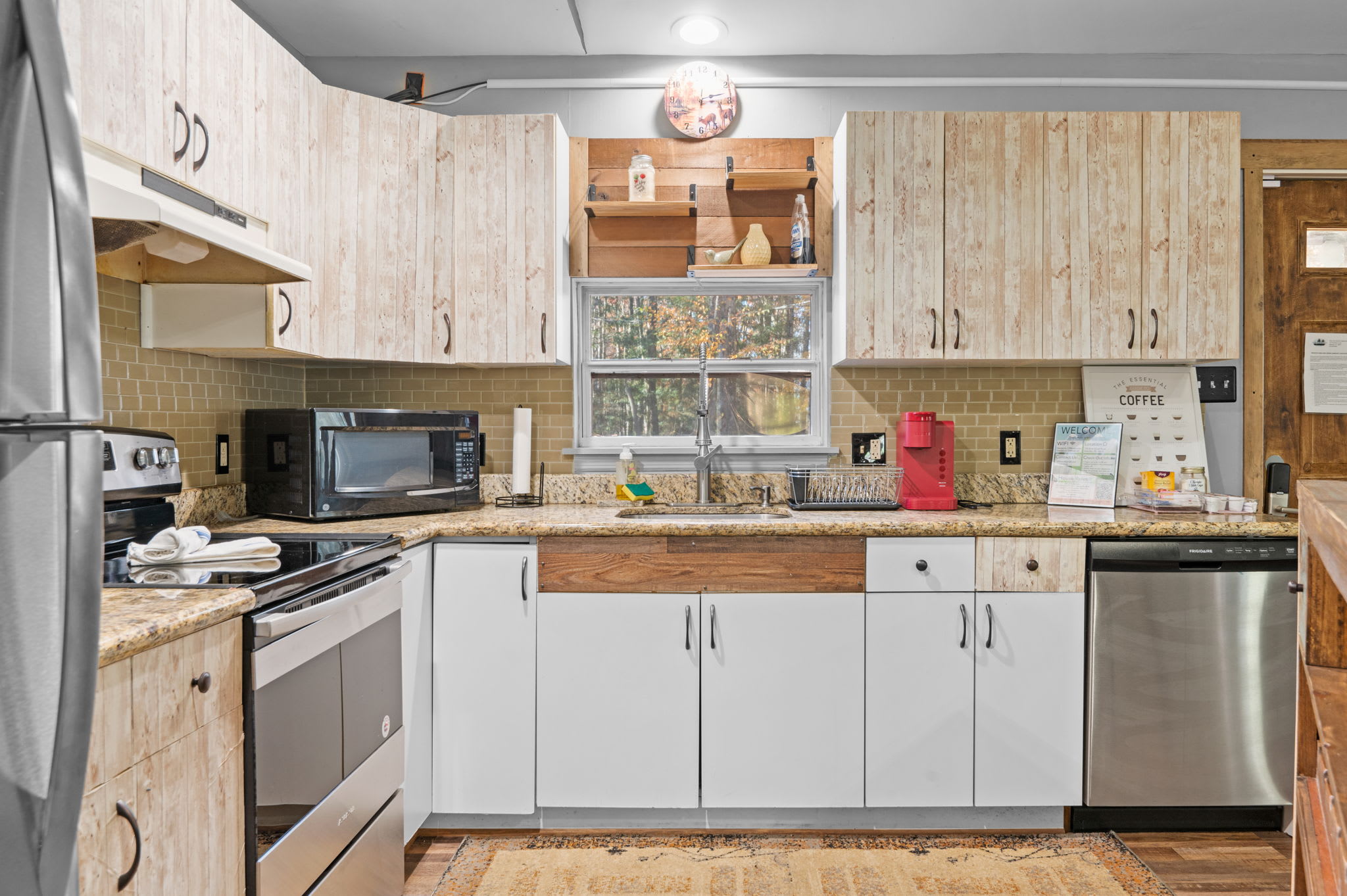 Rustic cabinetry and stainless steel appliances bring together modern convenience and cabin-inspired charm.