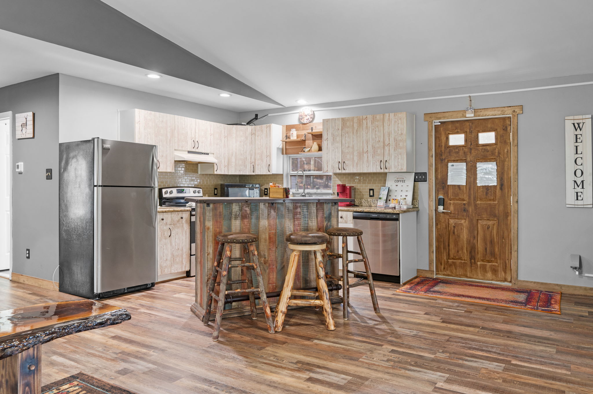 The warm, open layout invites easy conversation around the custom kitchen island with bar seating.