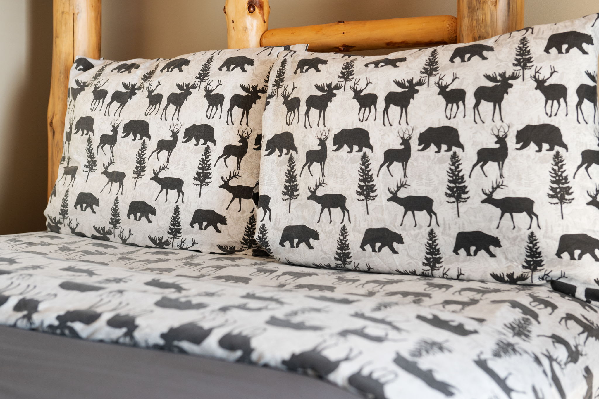Moose-themed linens add a playful, outdoorsy flair, perfectly echoing the home’s cabin-inspired charm.