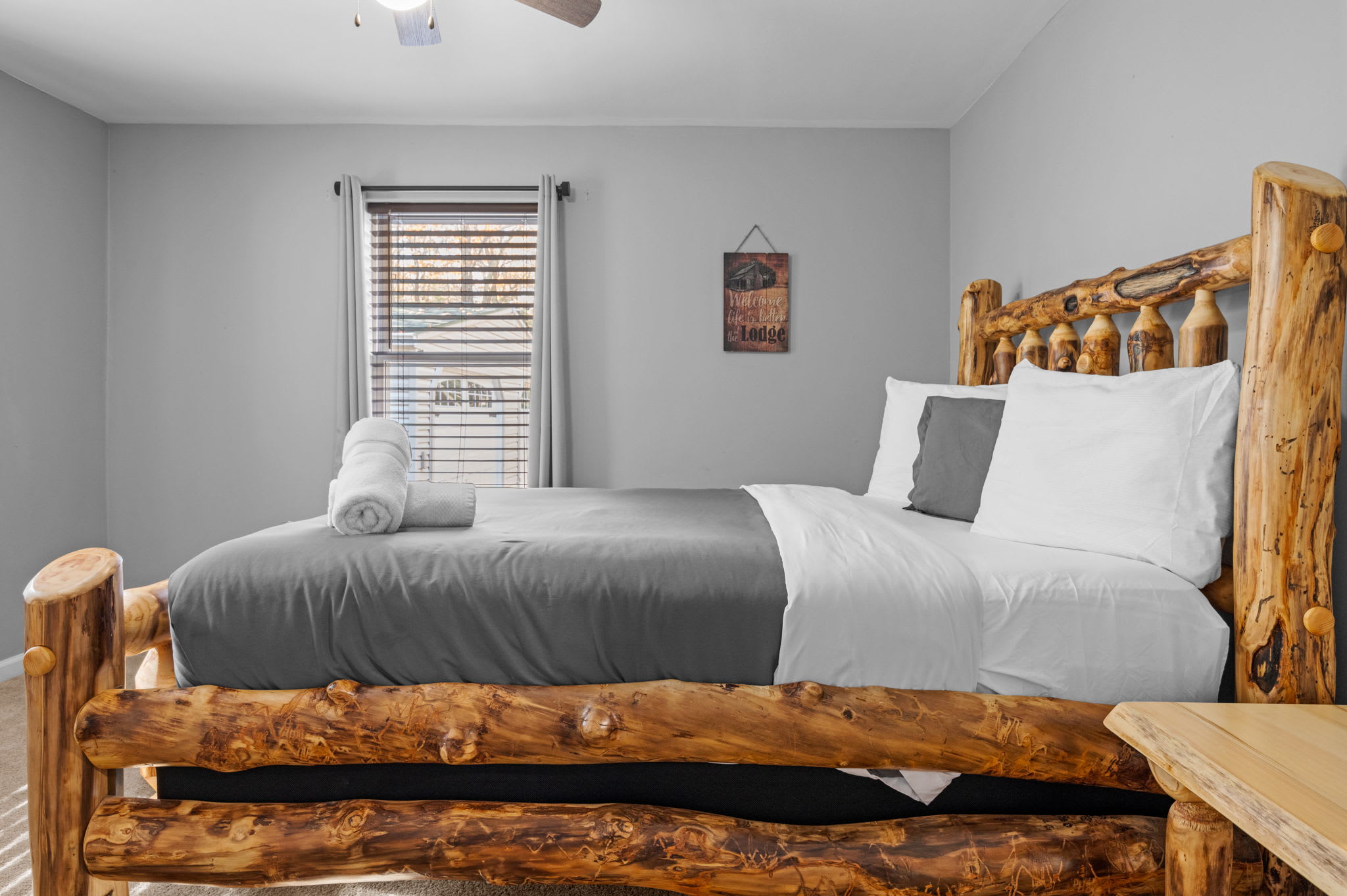 A curated space that harmonizes handcrafted design with modern amenities. The unique wooden bed serves as a focal point, complemented by crisp linens and a neutral palette that invites relaxation and understated sophistication.