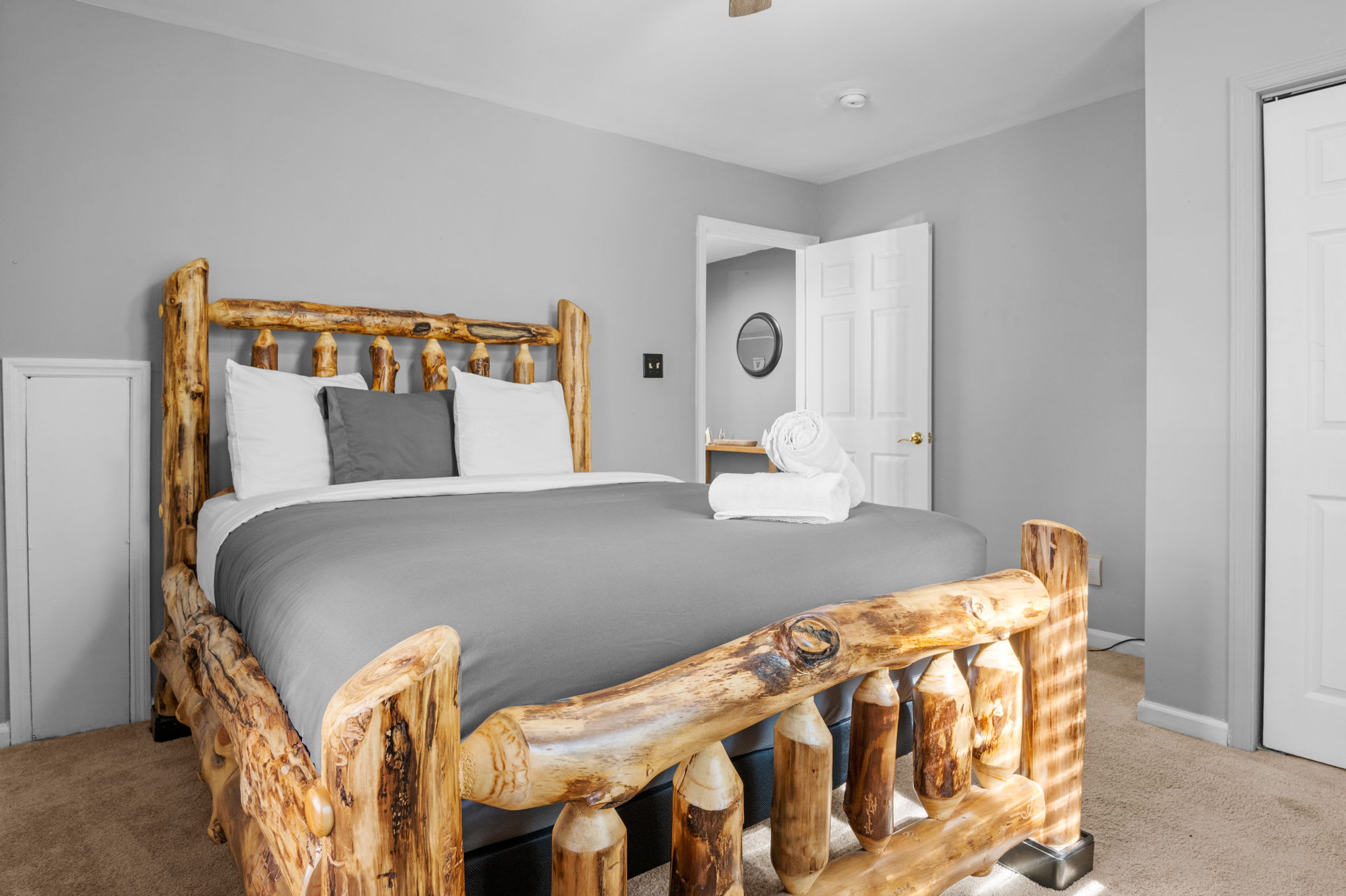 A handcrafted log bed stands as the centerpiece, offering a rustic yet refined sleeping experience.