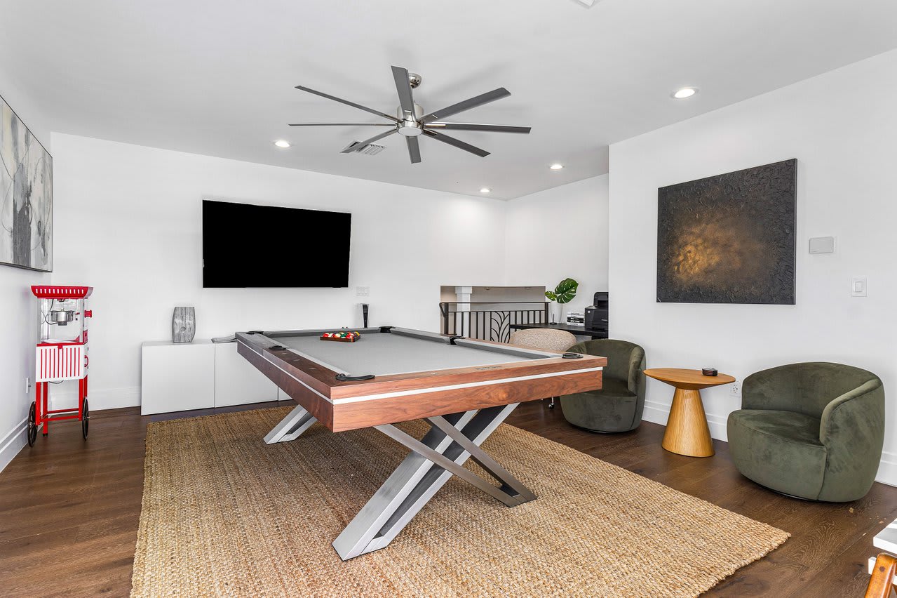Gather for friendly competition in the game room, complete with a sleek pool table, comfy seating, and a Smart TV.