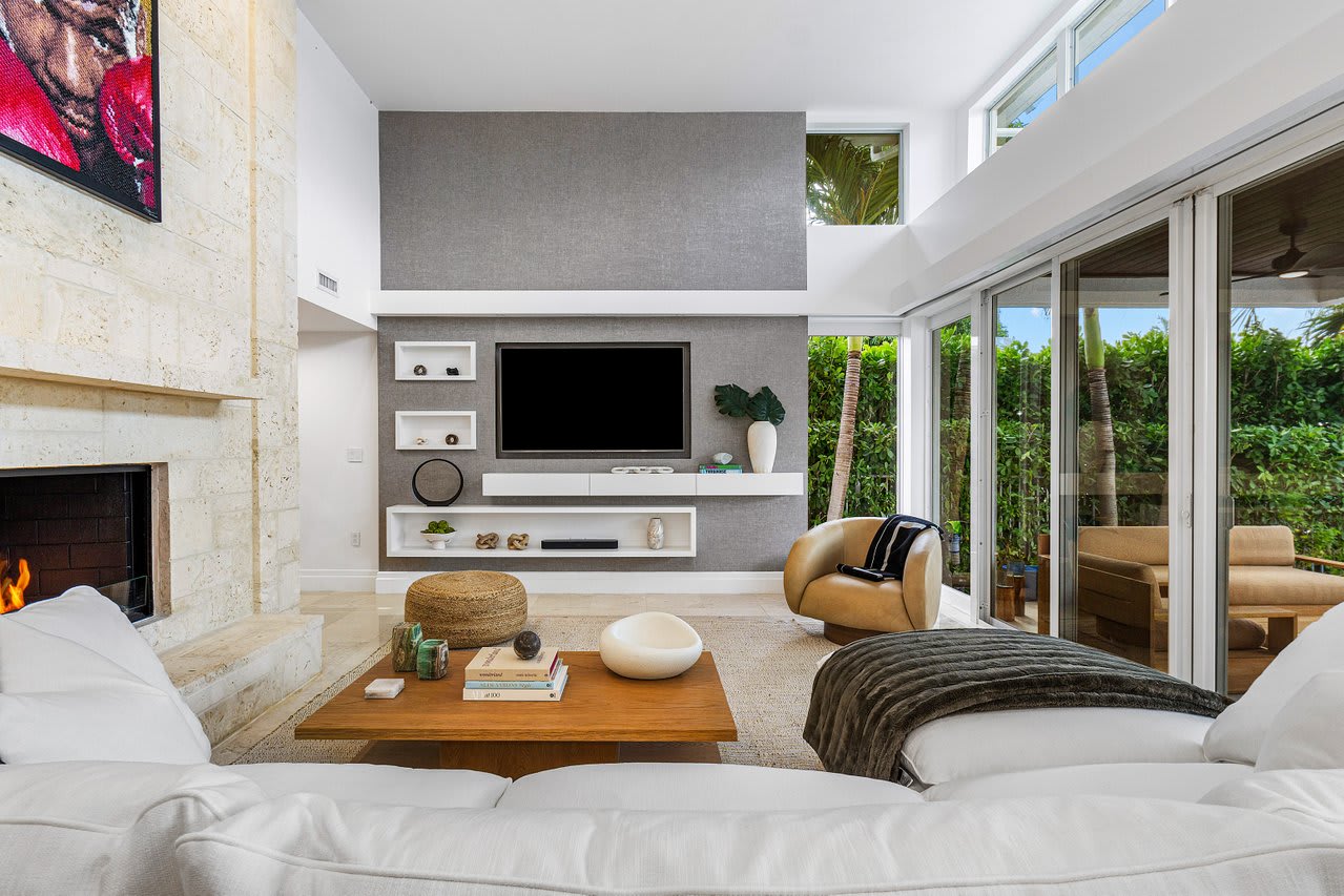 Expansive living room with floor-to-ceiling views and seamless access to the outdoor oasis.