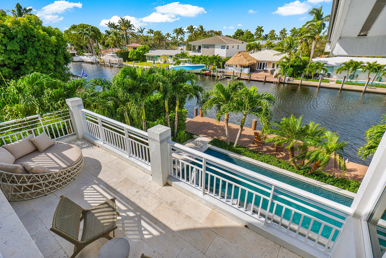 Private balcony with serene views of the pool and canal, ideal for peaceful mornings and quiet afternoons.