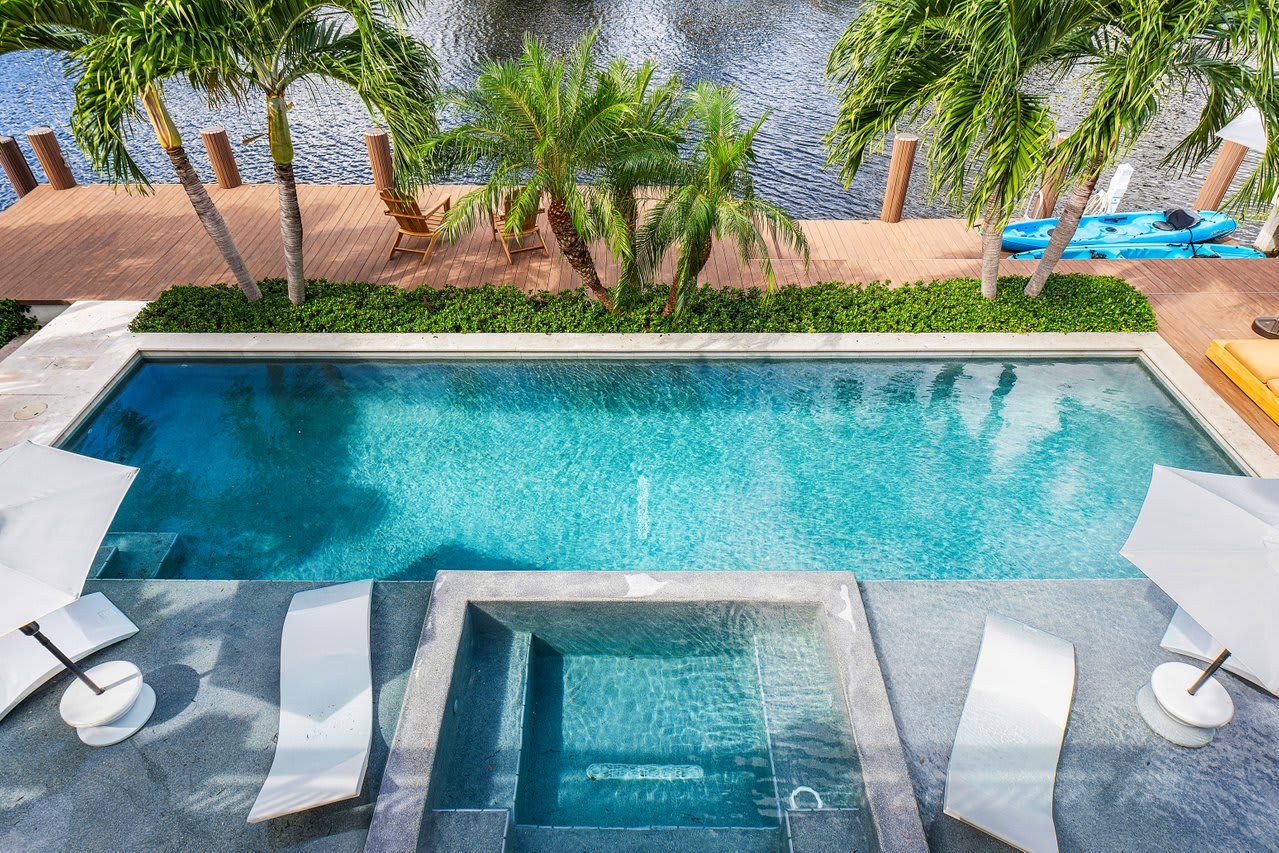 Resort-style pool with Baja deck and lounge chairs, perfect for soaking up the sun and enjoying the Florida warmth.