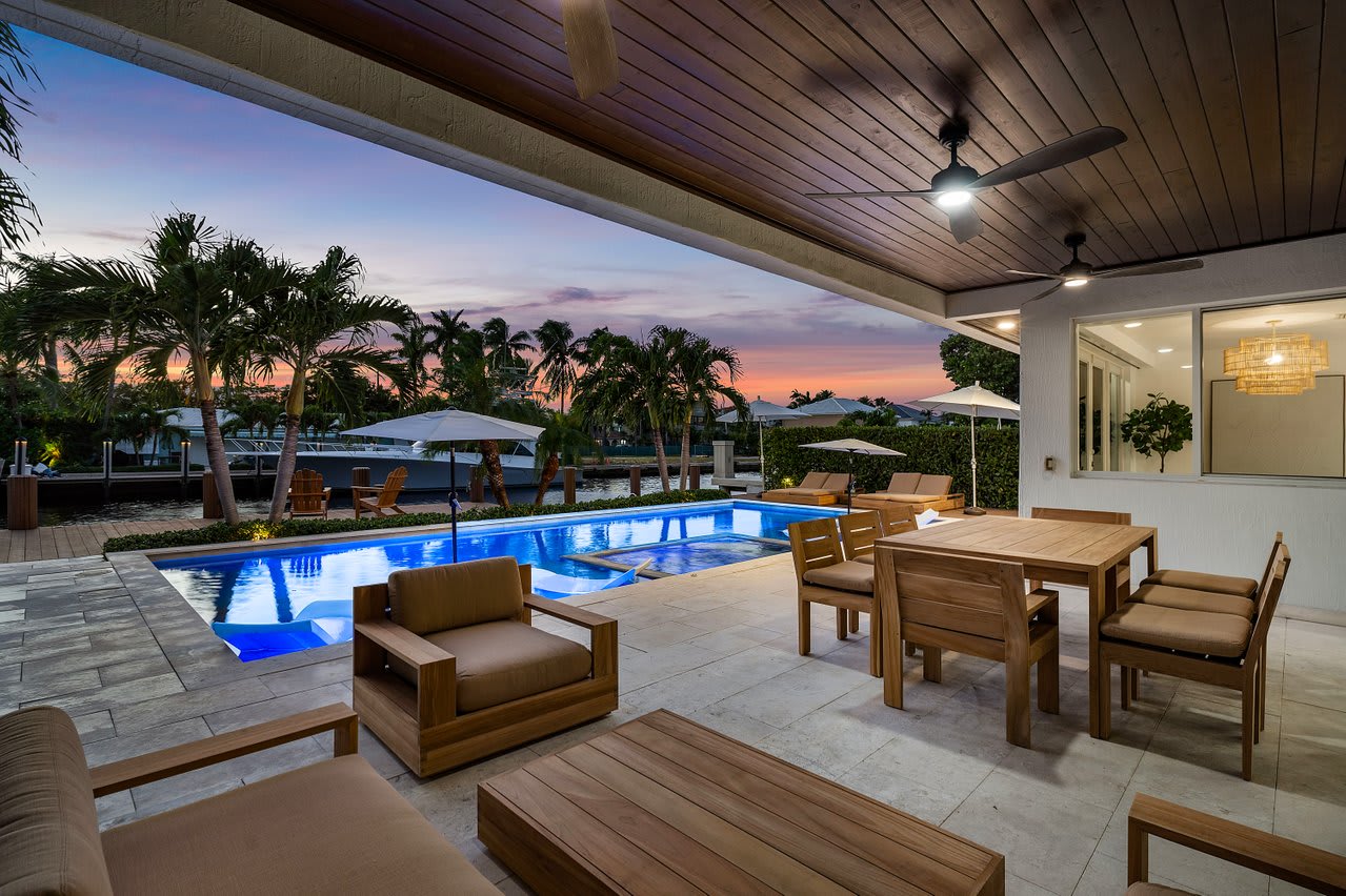 End your day poolside with cozy seating, ambient lighting, and serene water views.