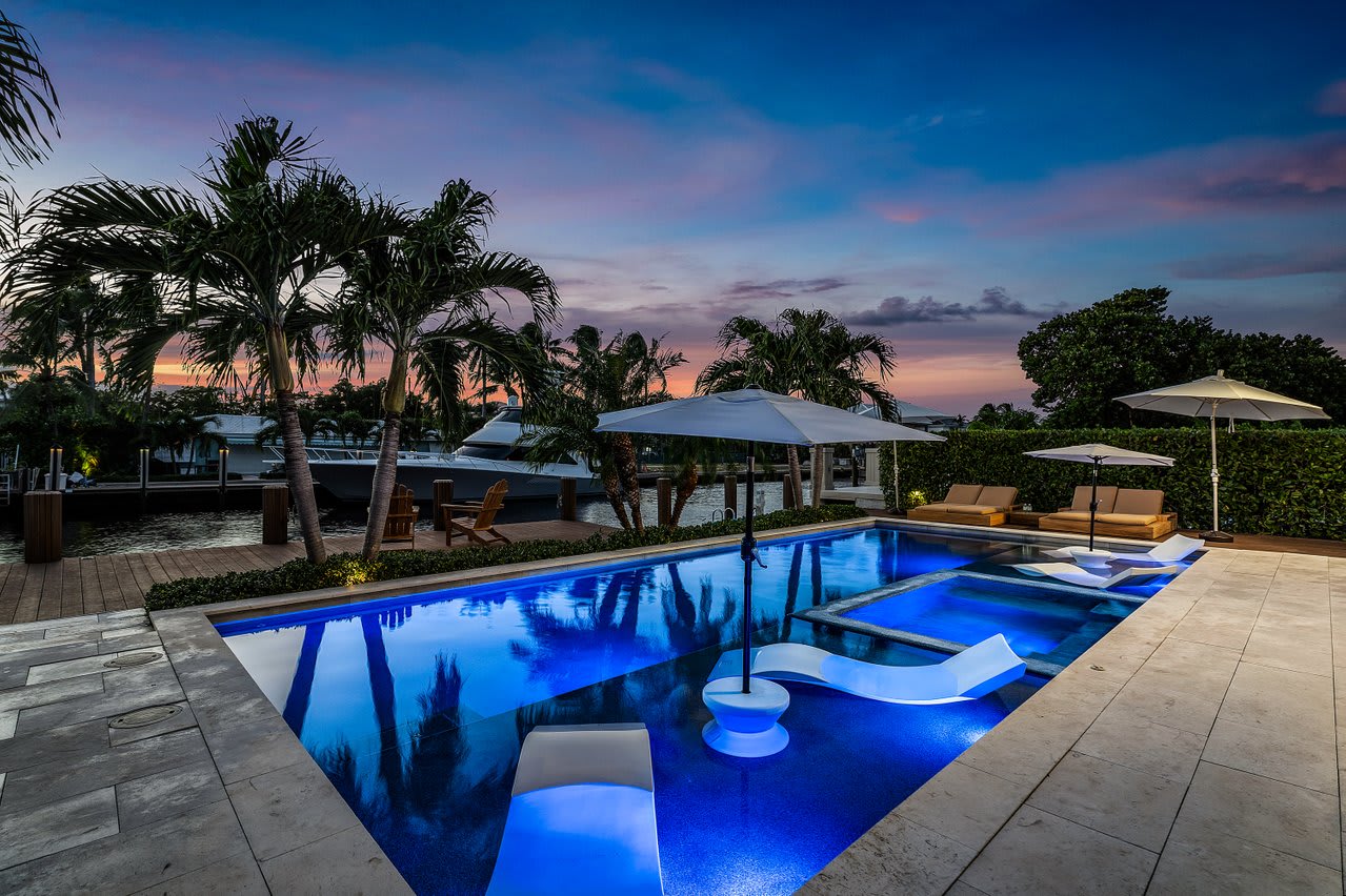 Evenings by the pool are pure magic, with serene lighting and tropical palms.
