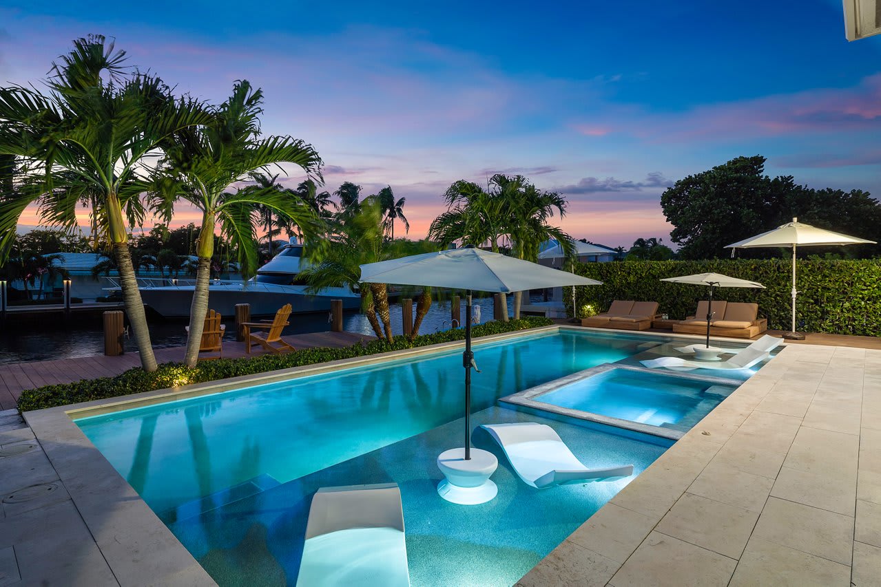Luxurious loungers, tranquil water views, and the warm glow of a Florida sunset setting.