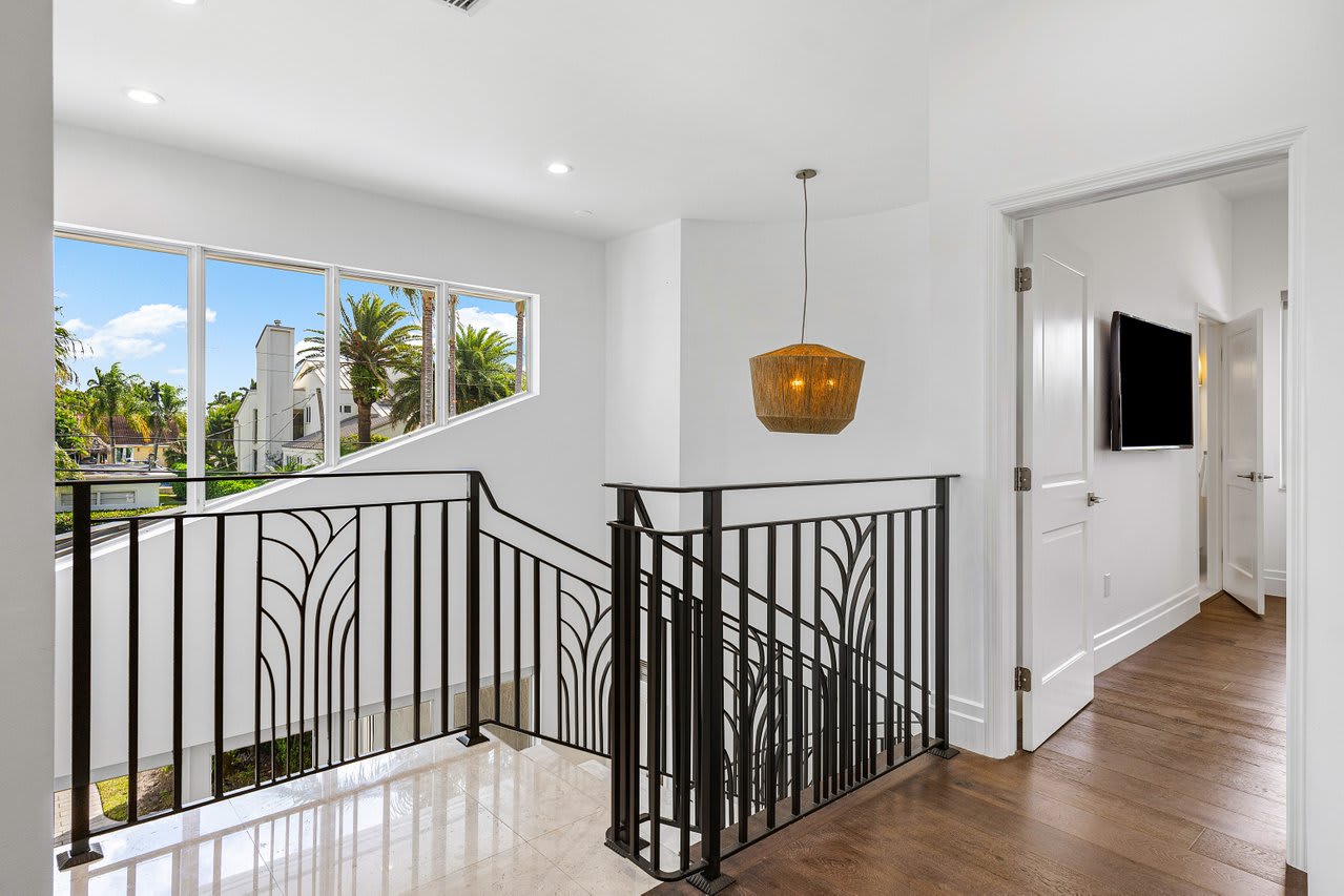Ascend to the upper level and enjoy bright, open views framed by elegant wrought-iron railings.