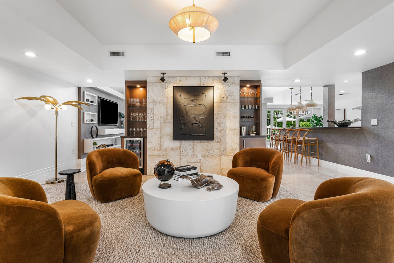 Rich velvet seating and warm, textured fabrics against neutral tones - perfect for unwinding in style.