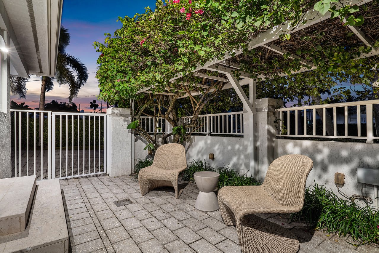 Enjoy quiet moments on the private patio, surrounded by lush greenery and comfortable seating.