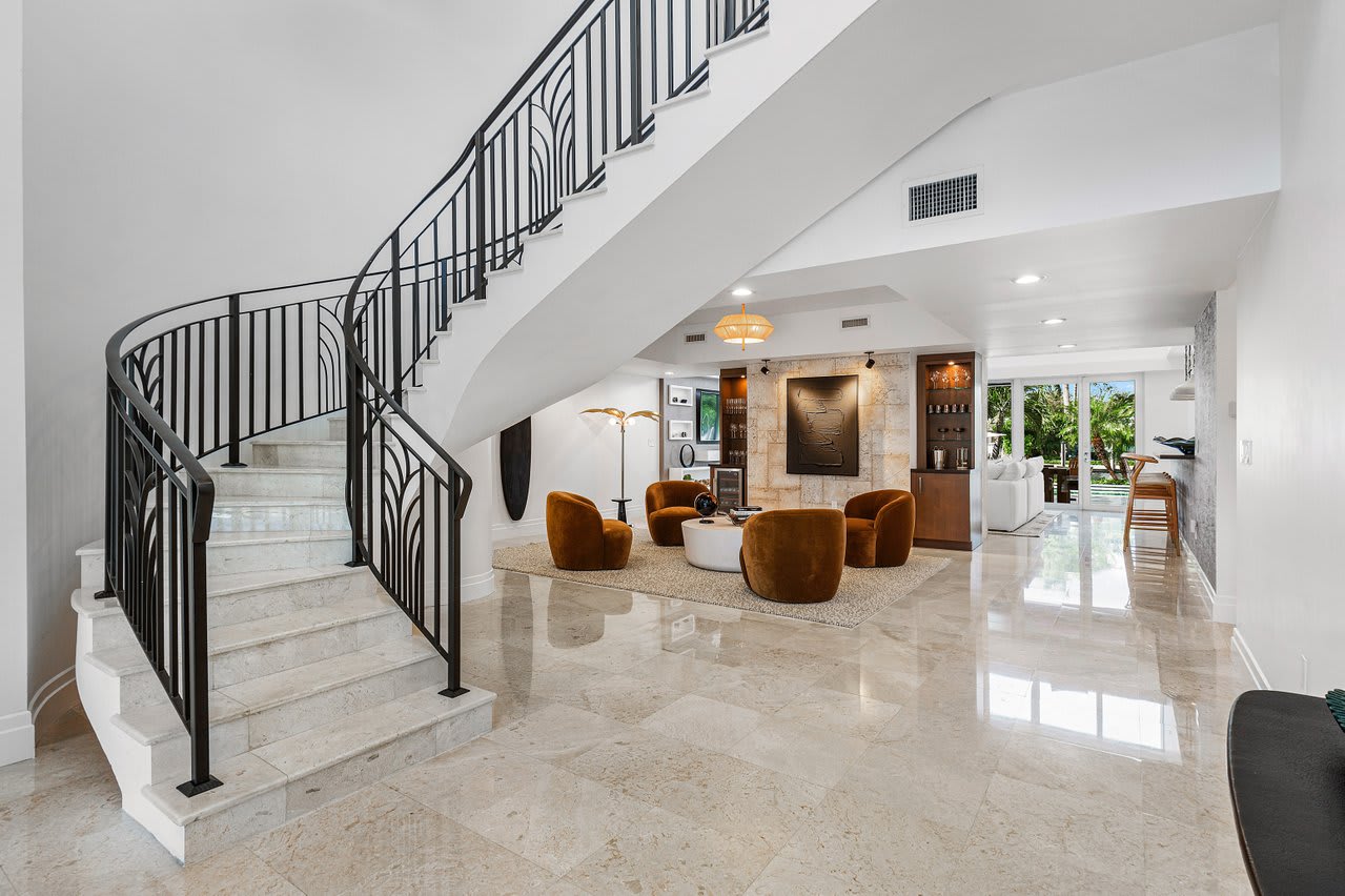Elegant staircase leading to the upper level, showcasing refined architectural details.