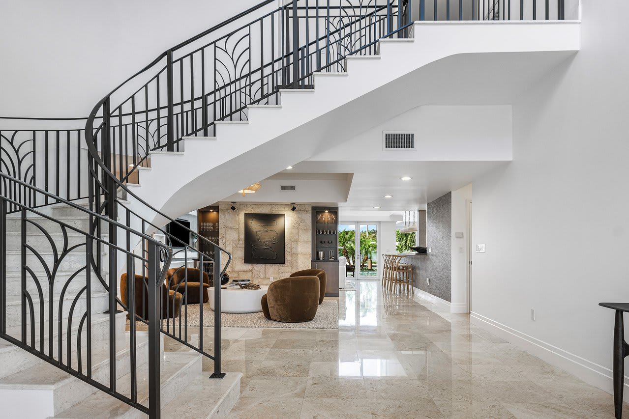 Grand staircase with timeless wrought-iron railings and smooth marble steps, a true focal point.