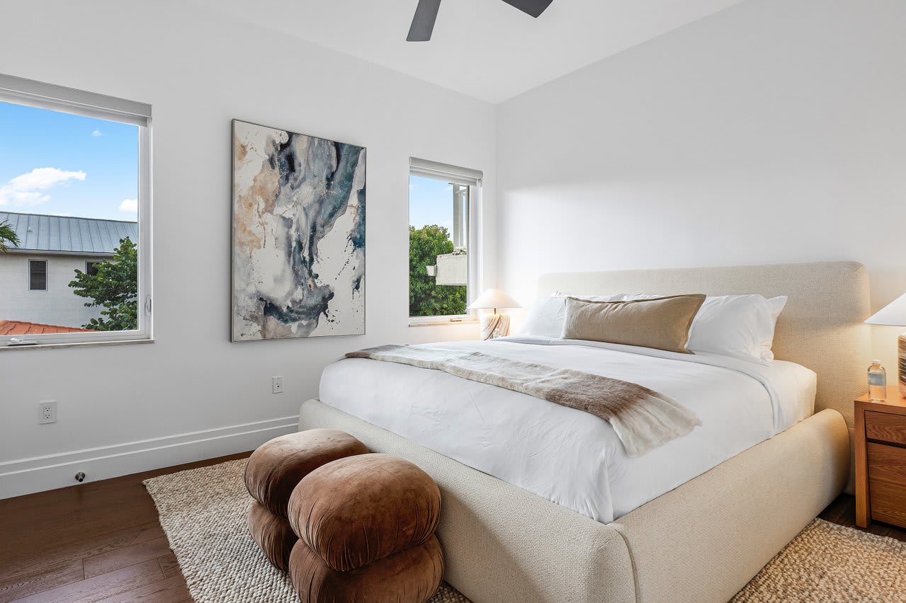 Comfortable Guest Bedroom with a plush king bed, soft woven rugs, and natural wood accents, all bathed in gentle natural light.