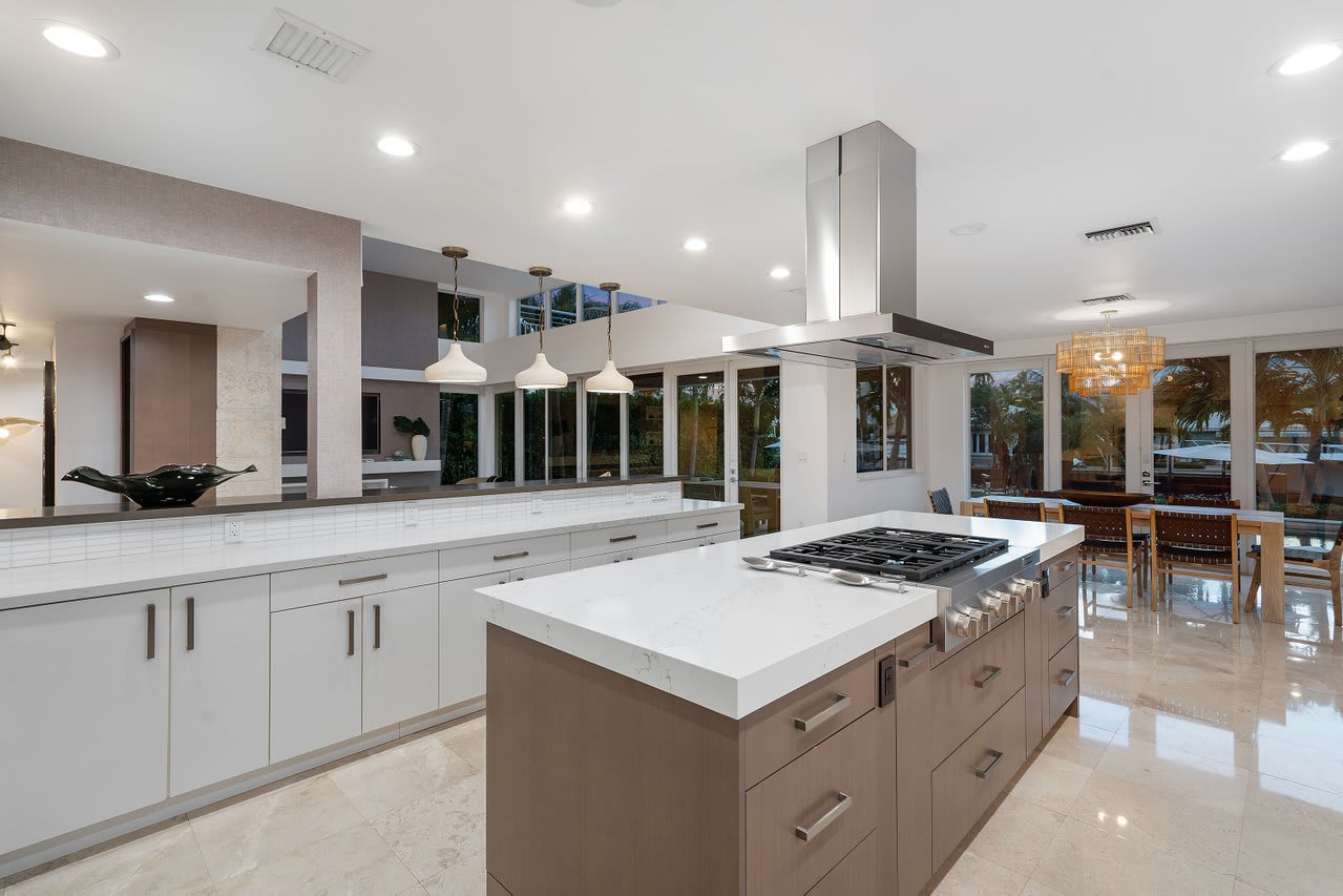 Chef’s kitchen with stainless steel appliances, quartz countertops, and a sleek island with bar seating.