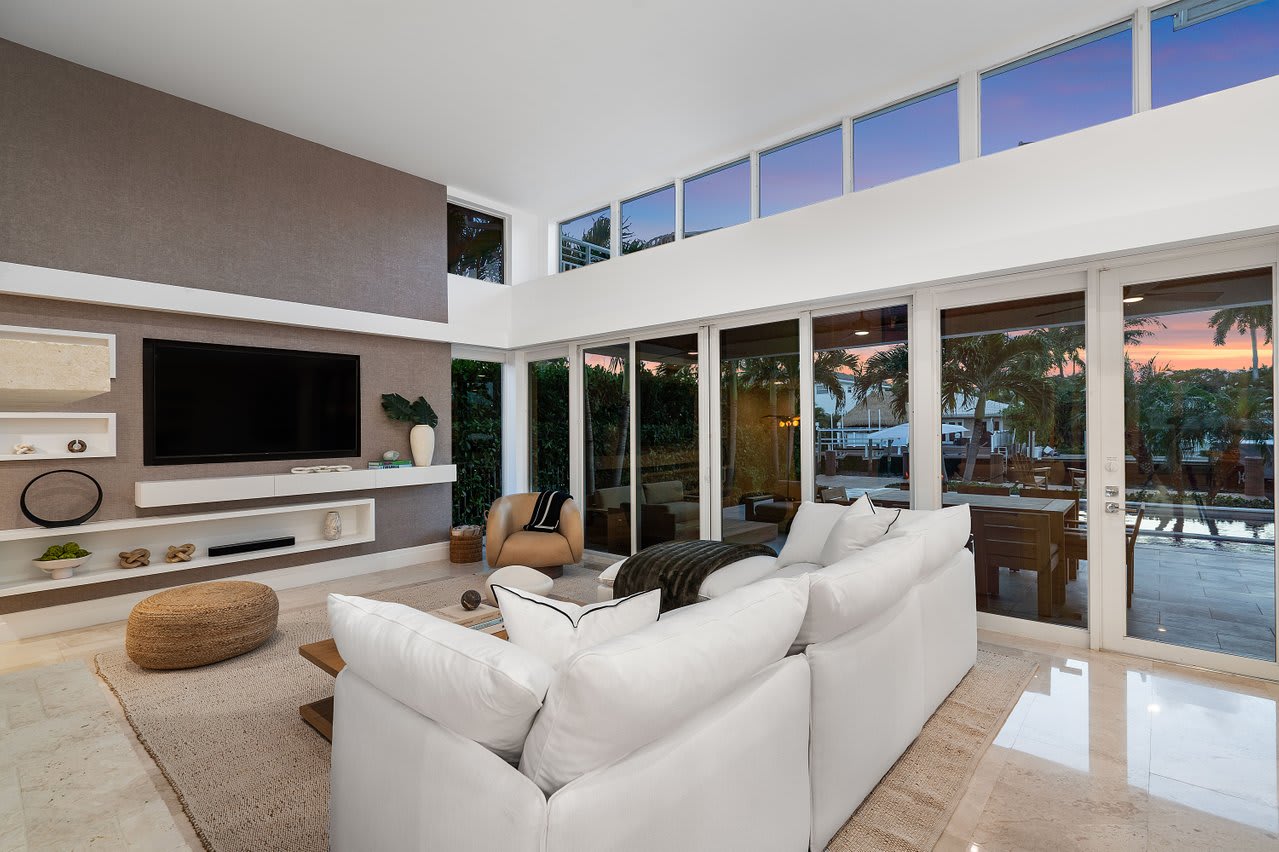 Comfortable living area with expansive windows, a modern fireplace, and expansive seating for memorable moments together.