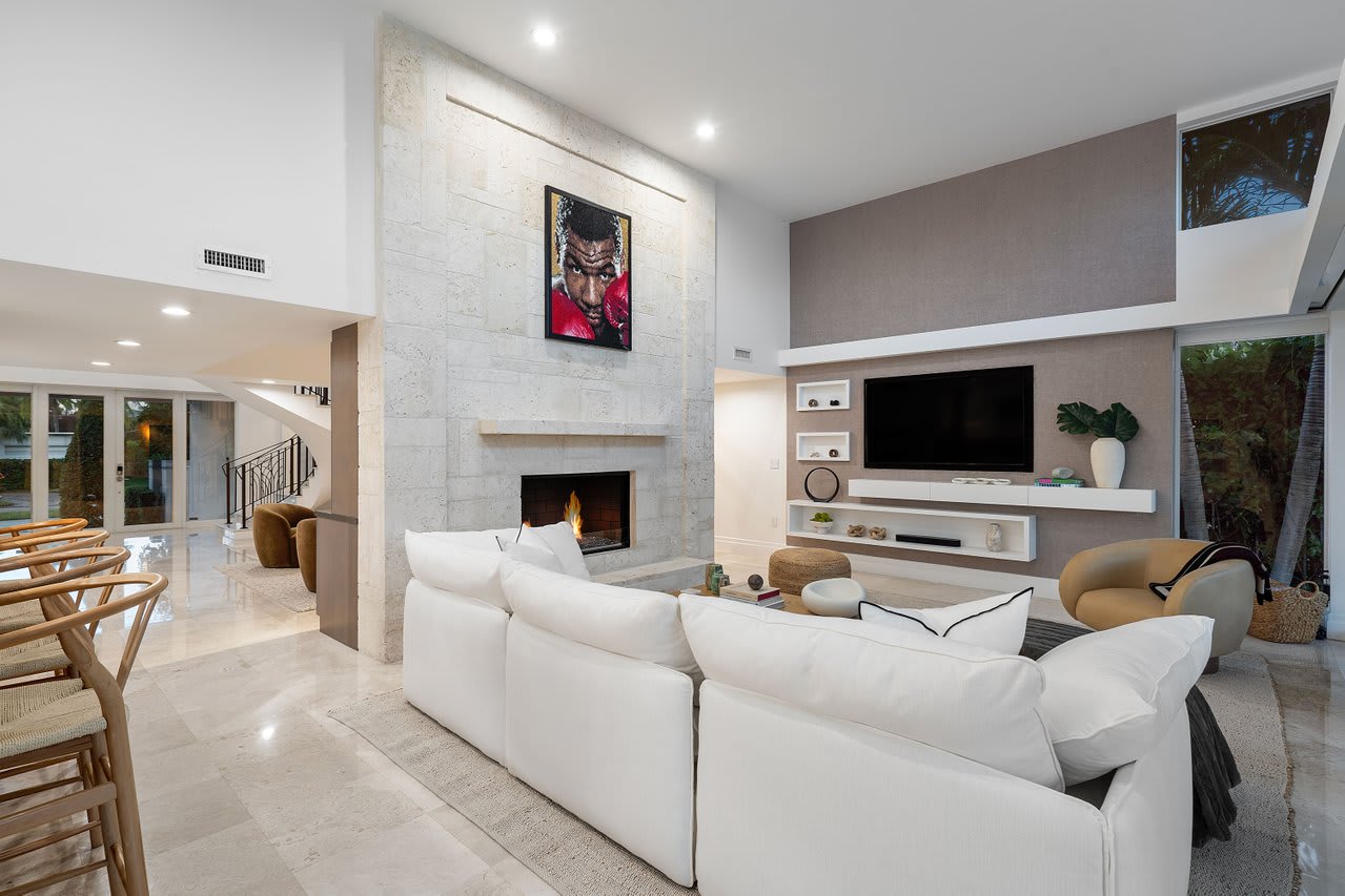 Refined living space centered around a sleek fireplace and surrounded by open views.
