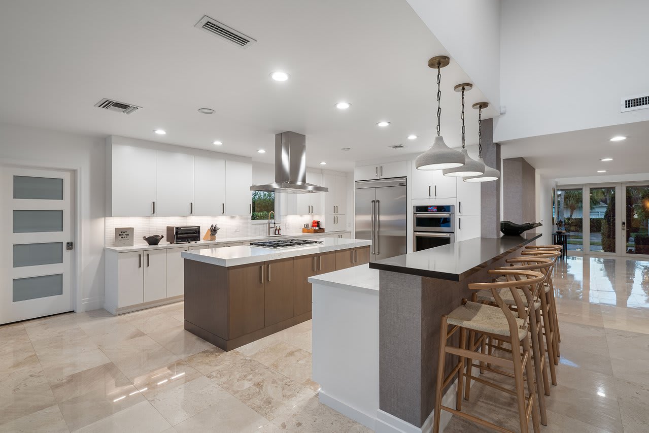 A spacious kitchen, featuring high-end appliances and a sleek island with bar seating for casual meals.