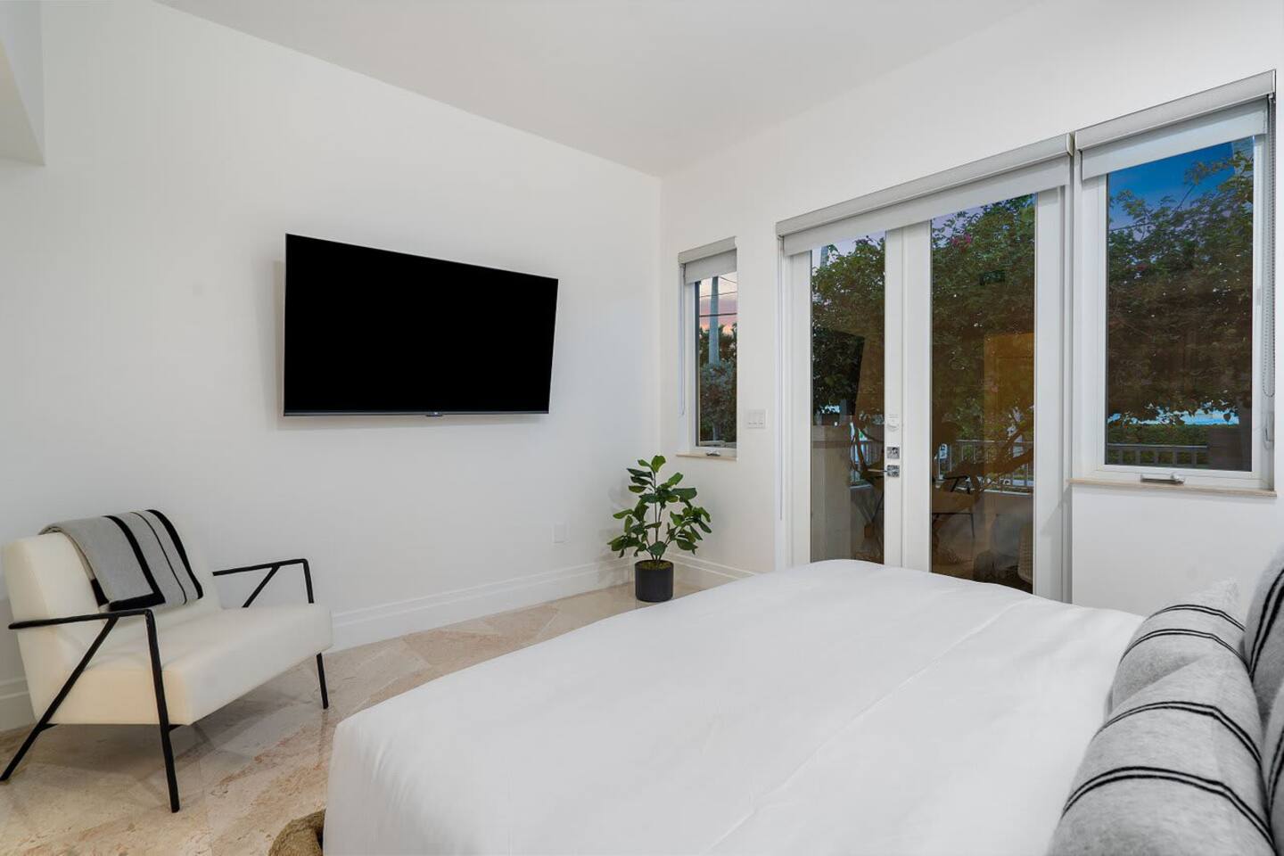 Relax in this tranquil bedroom featuring soft natural tones and private garden access.
