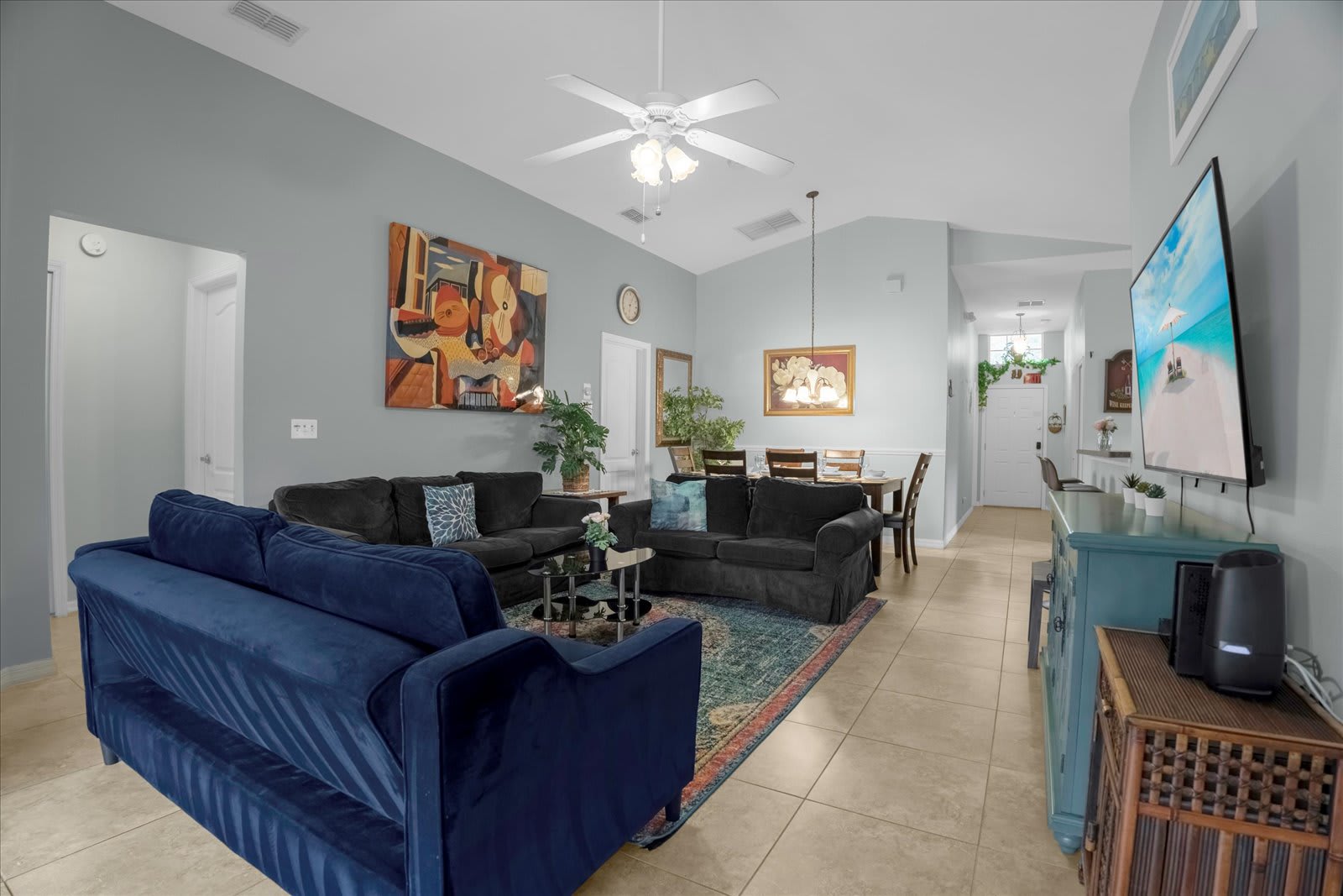 Spacious Living Area With Comfortable Sofas, A Dining Area, And A Smart TV