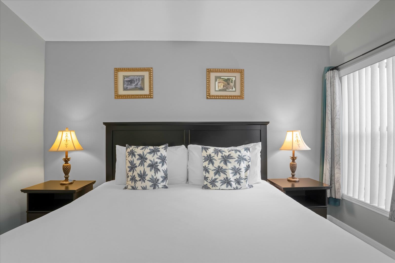 Cozy Bedroom With A Queen-Size Bed, Accent Lamps, And Beautiful Art