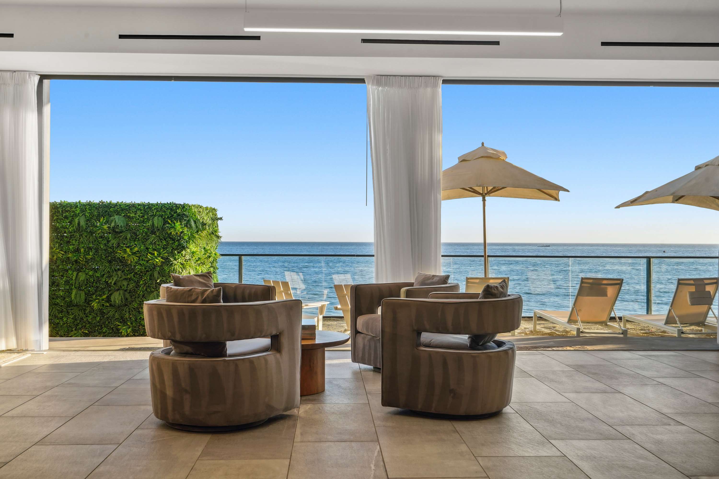 Sink into plush sofas, unwind, and let the ocean views inspire your stay.