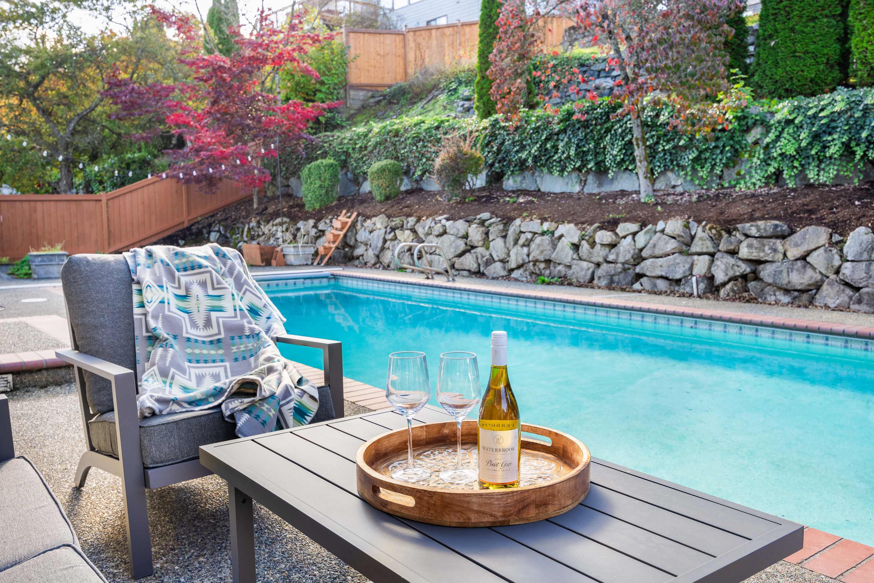 Pool side table and chair with champagne bottle