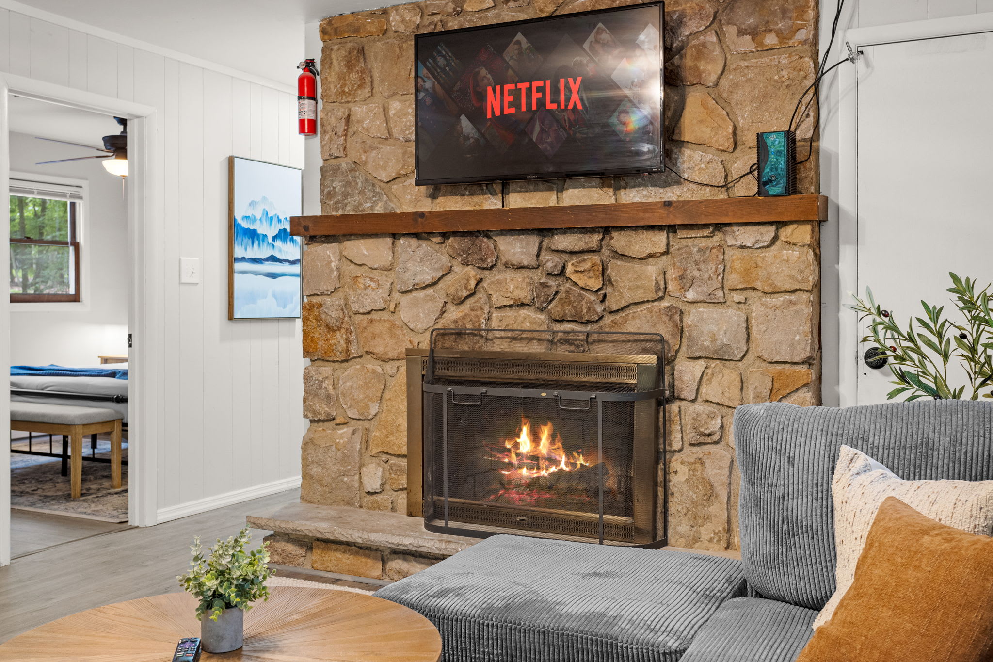 A spacious and modern gathering space featuring a fireplace and arcade games for ultimate fun and relaxation.