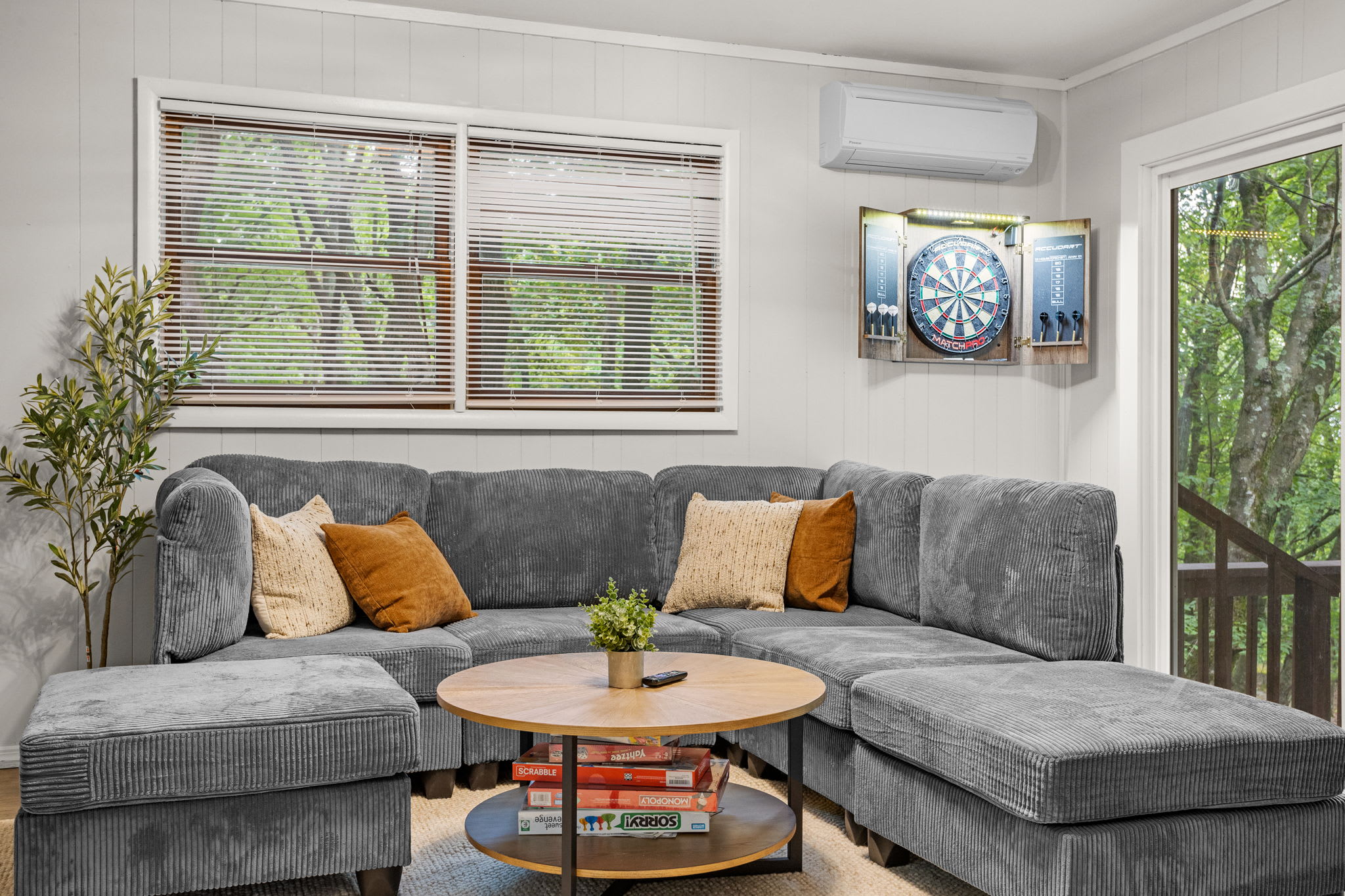 A modern lounge area with plush seating, large windows, and earthy tones, creating a warm and inviting atmosphere.