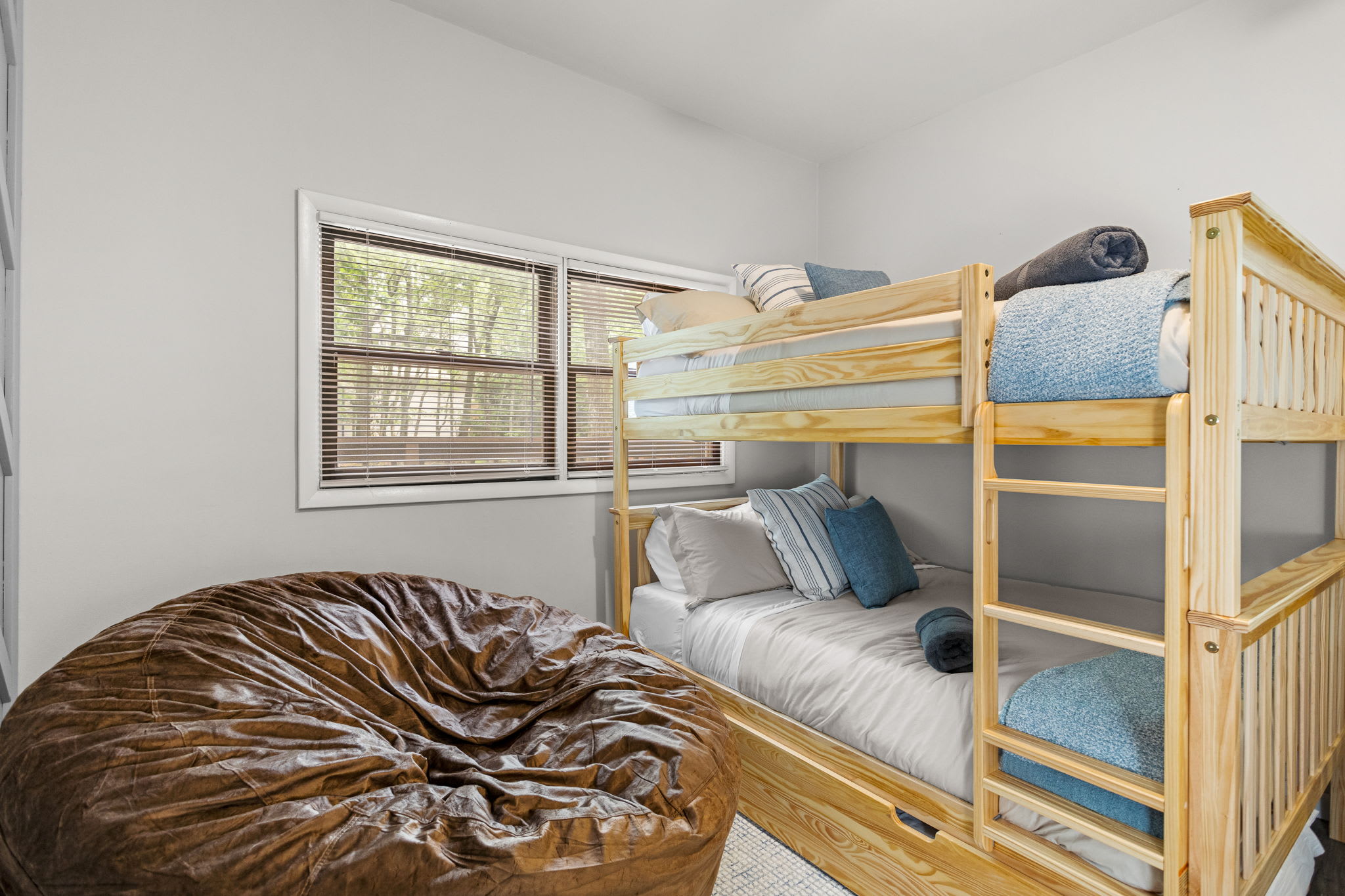 Another view of the bunk bed area, featuring a plush bean bag for relaxation.