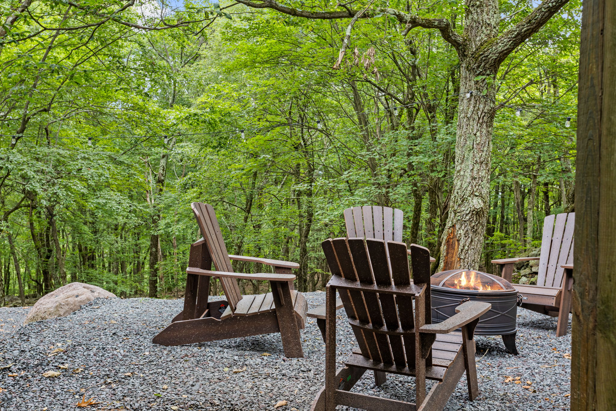 Cozy Fire Pit Gathering Area – A peaceful outdoor retreat featuring Adirondack chairs surrounding a fire pit, perfect for evenings under the stars.