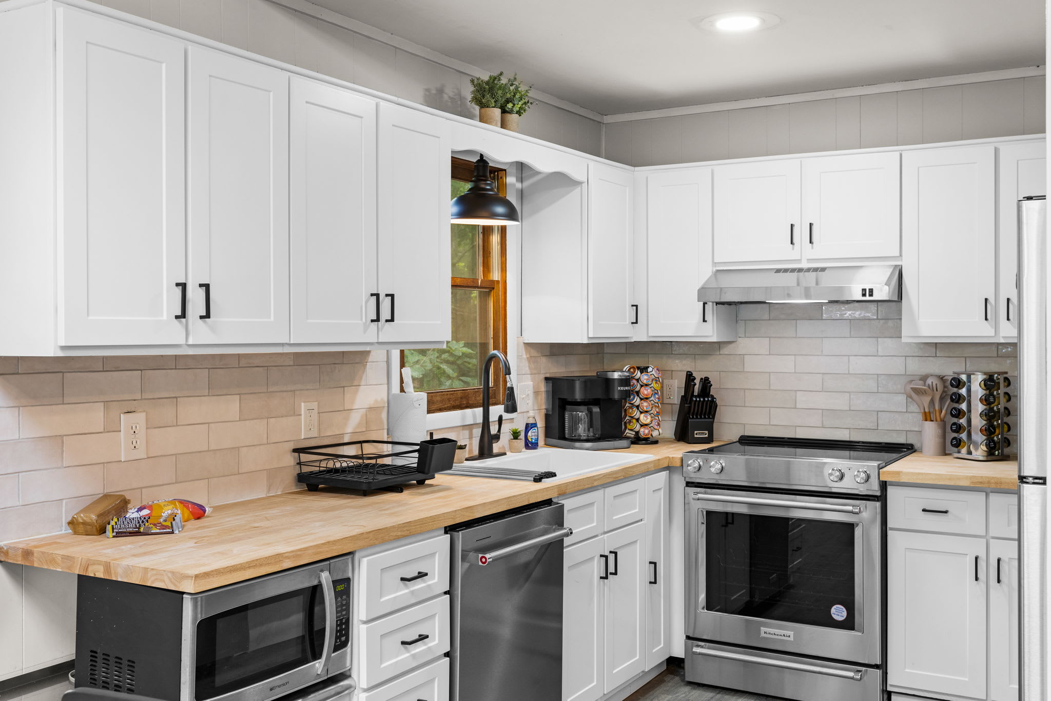 A different perspective of the kitchen, showing ample counter space and a well-organized layout.