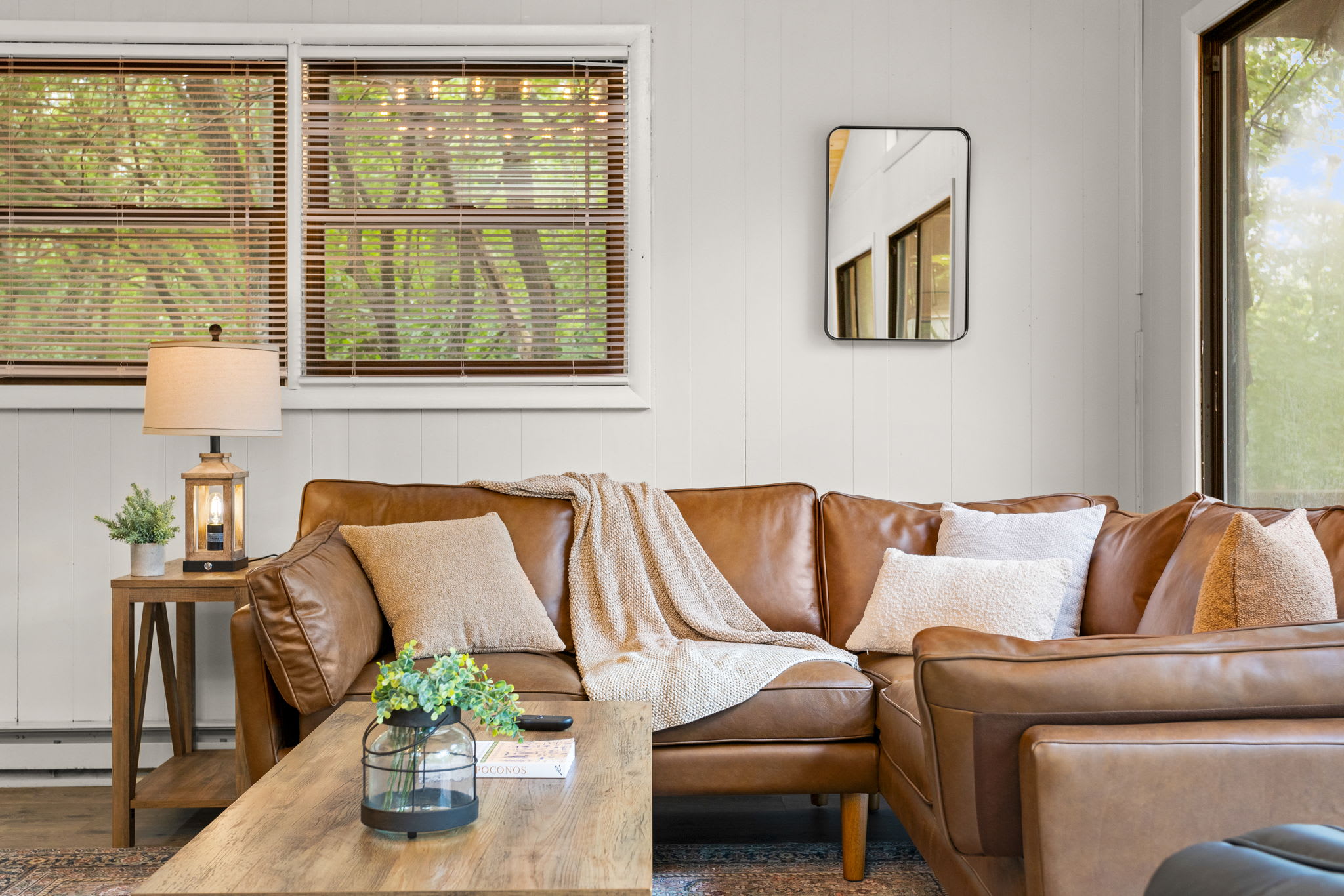 The caramel-toned leather couch against the bright interiors makes for an ultra-cozy yet refined space.