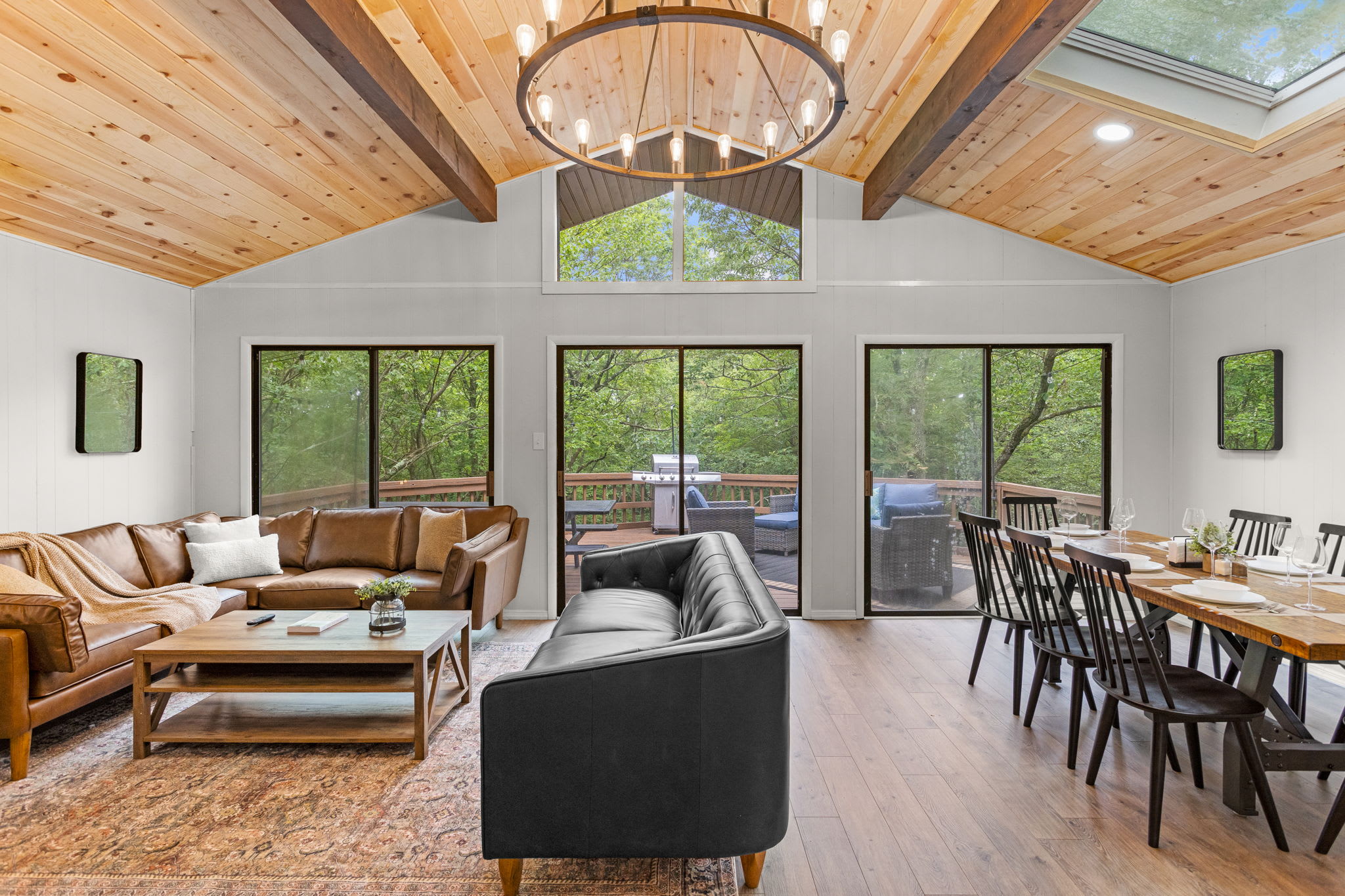 Large windows let in tons of natural light, making the living room feel airy and connected to the outdoors.