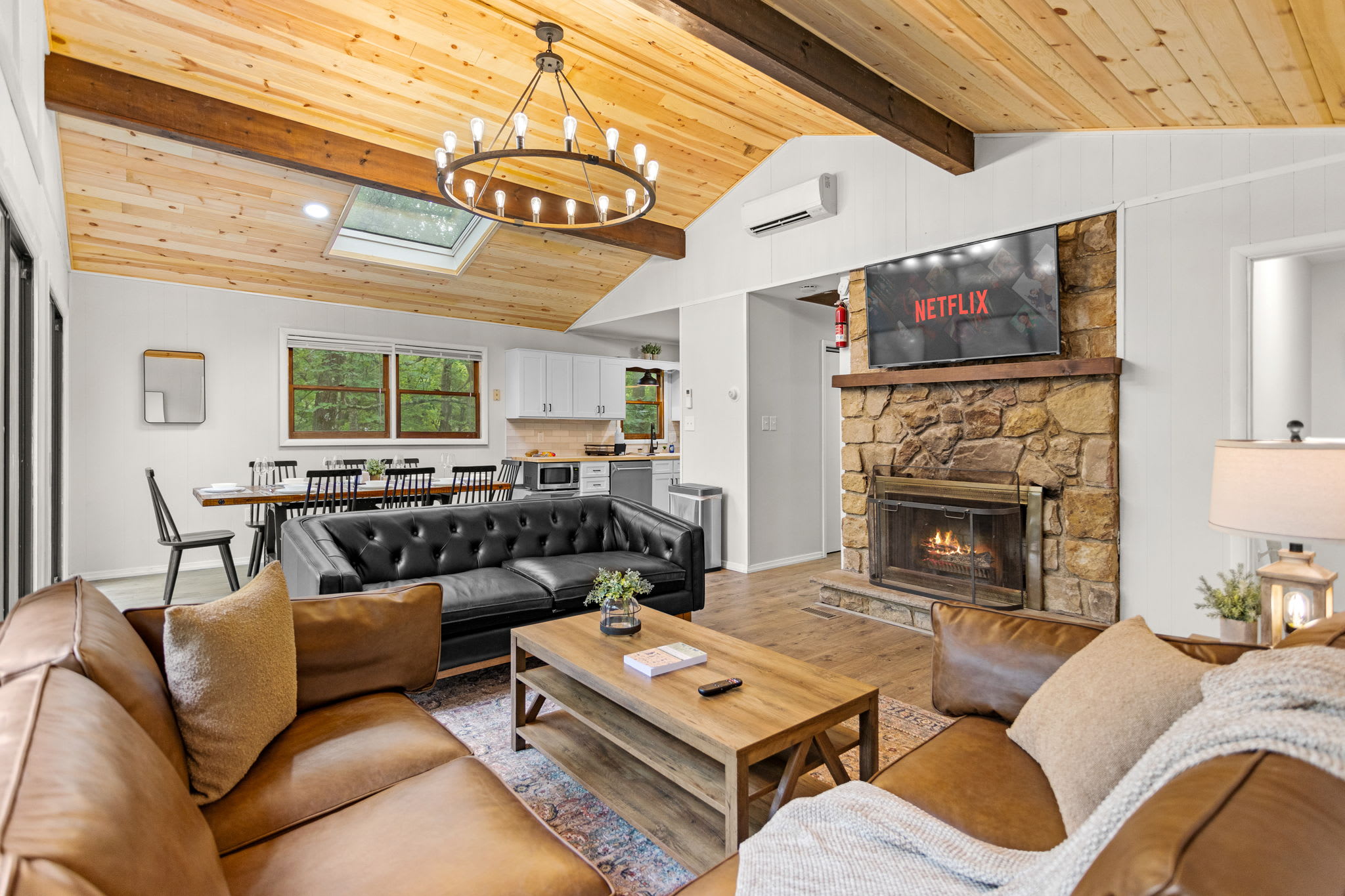 Rustic Yet Modern Living Room – A cozy and stylish living space featuring vaulted ceilings, warm wood accents, and a stone fireplace for the perfect mountain retreat.