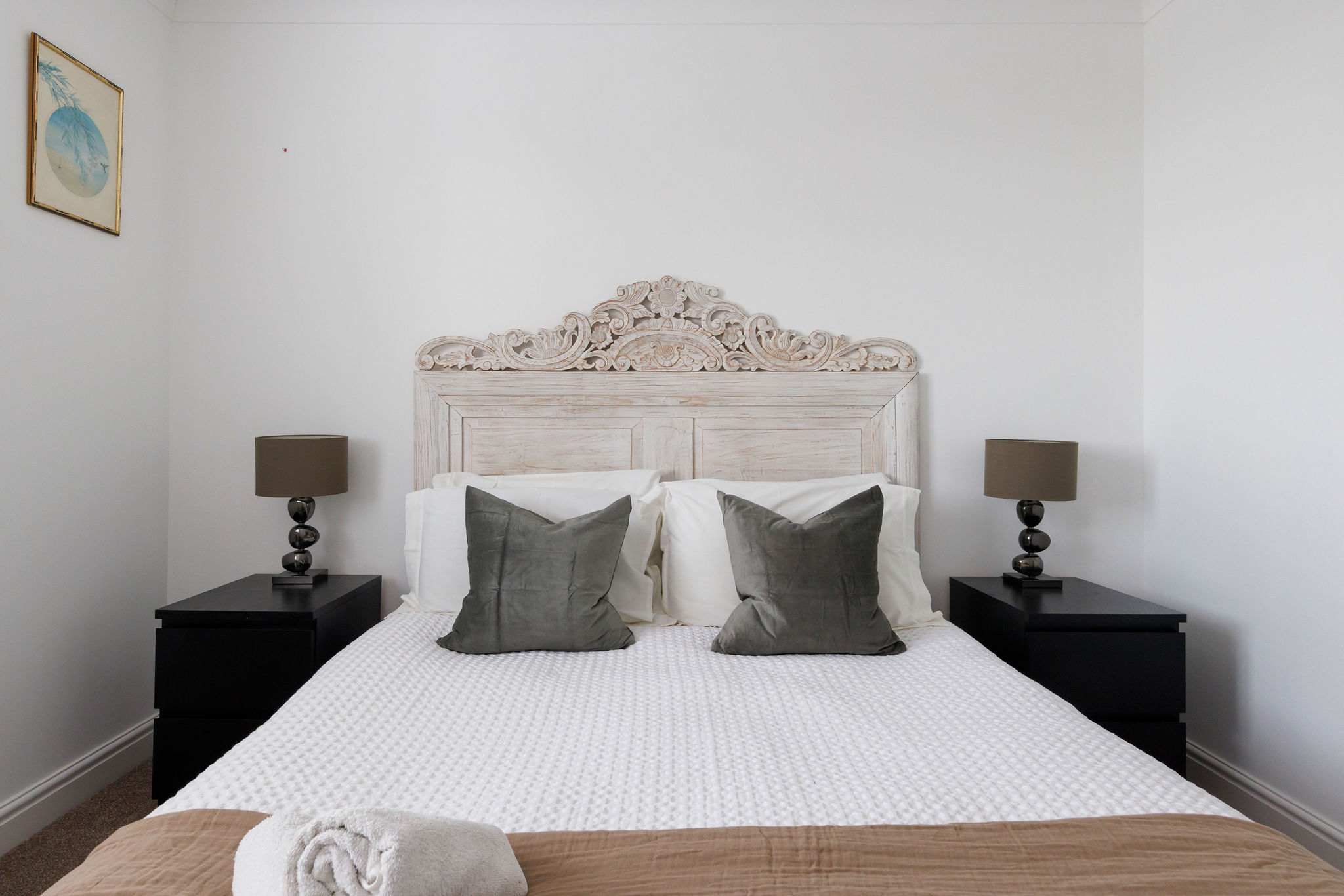 This king room has a beautiful decorative headboard.