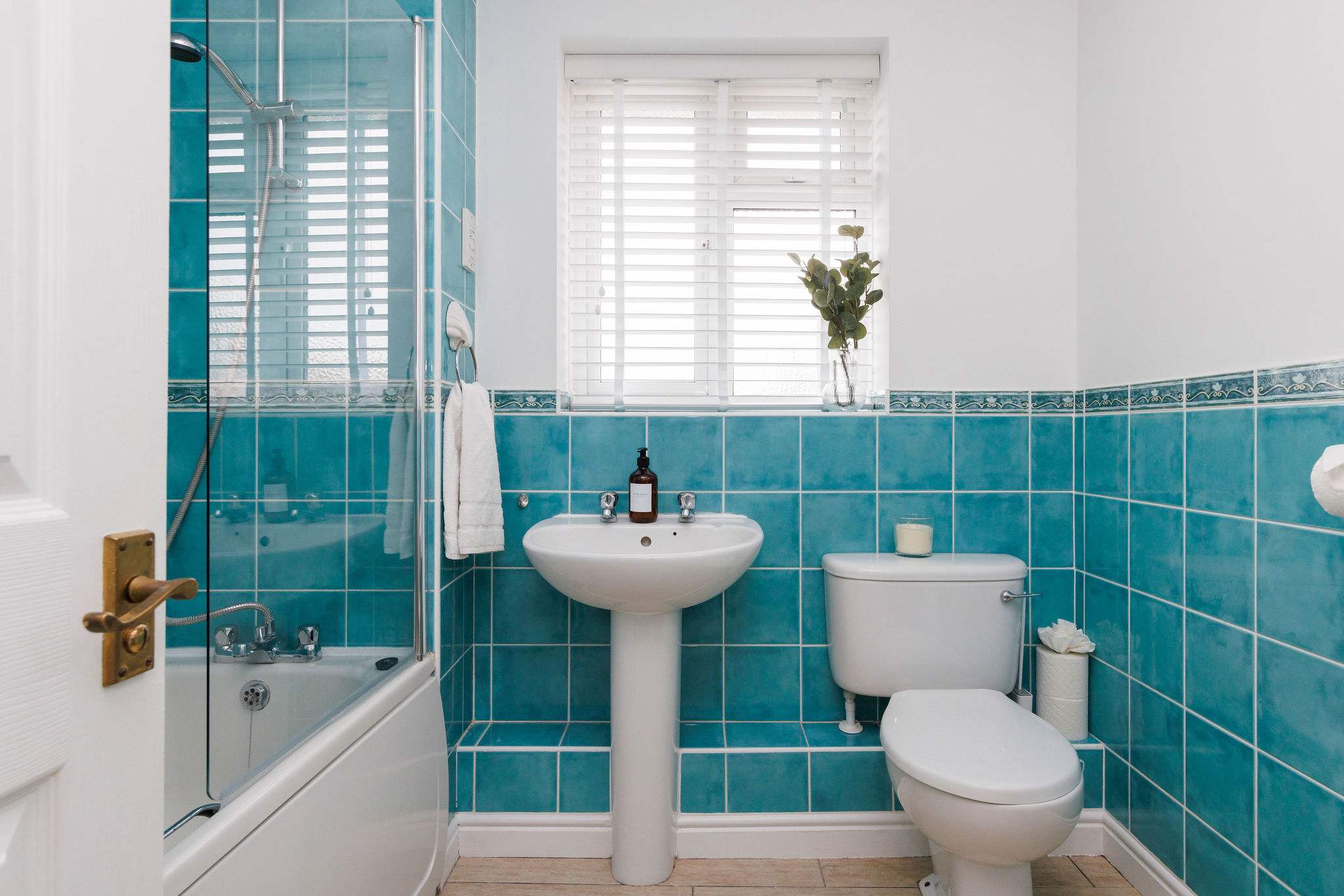 The family bathroom has an over bath shower, WC and sink.