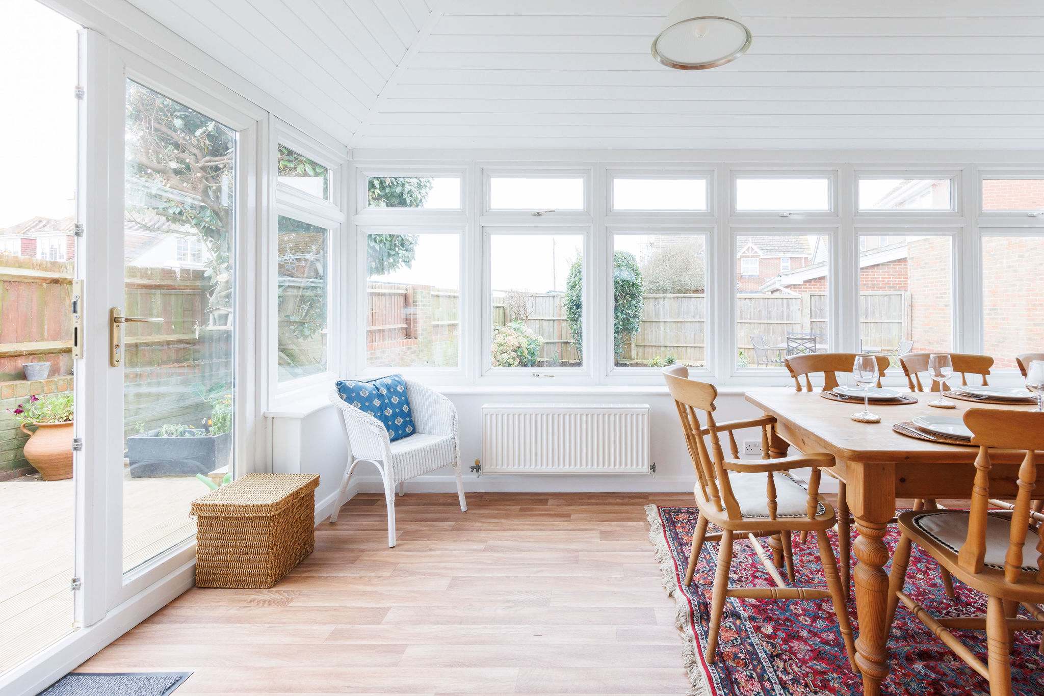 The conservatory is light and spacious. On warmer days, open the doors and enjoy the sea breeze over breakfast or lunch.