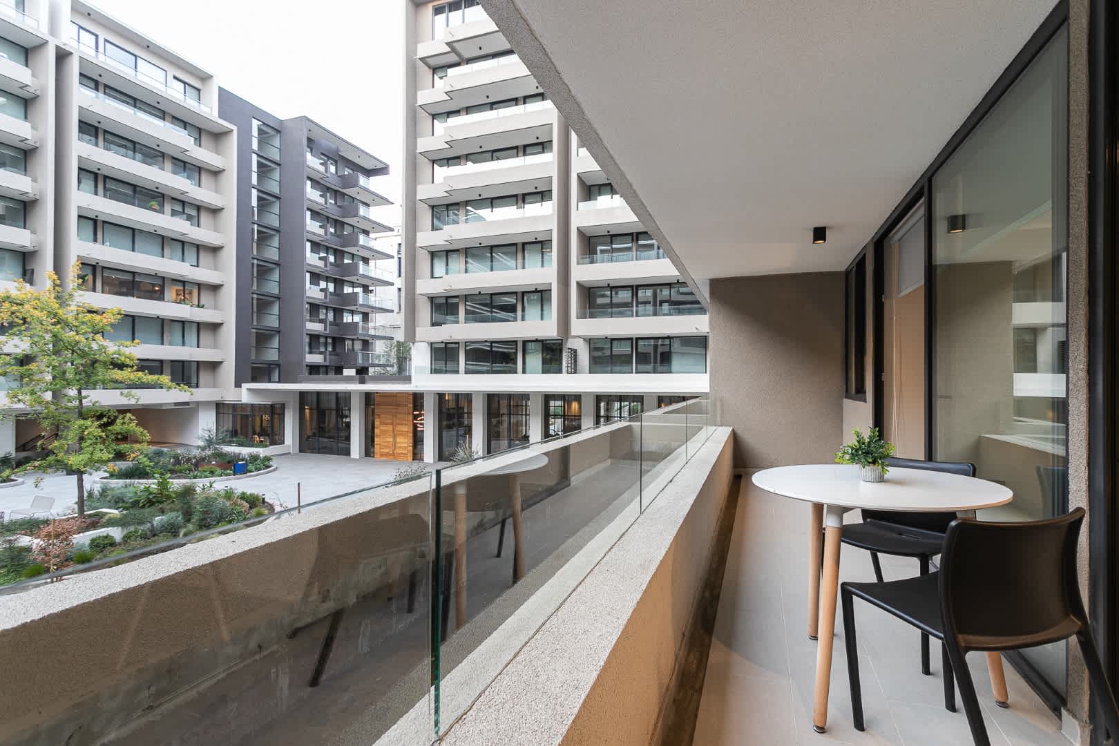 Enjoy your morning coffee on this sleek balcony with stunning city views and modern comfort.