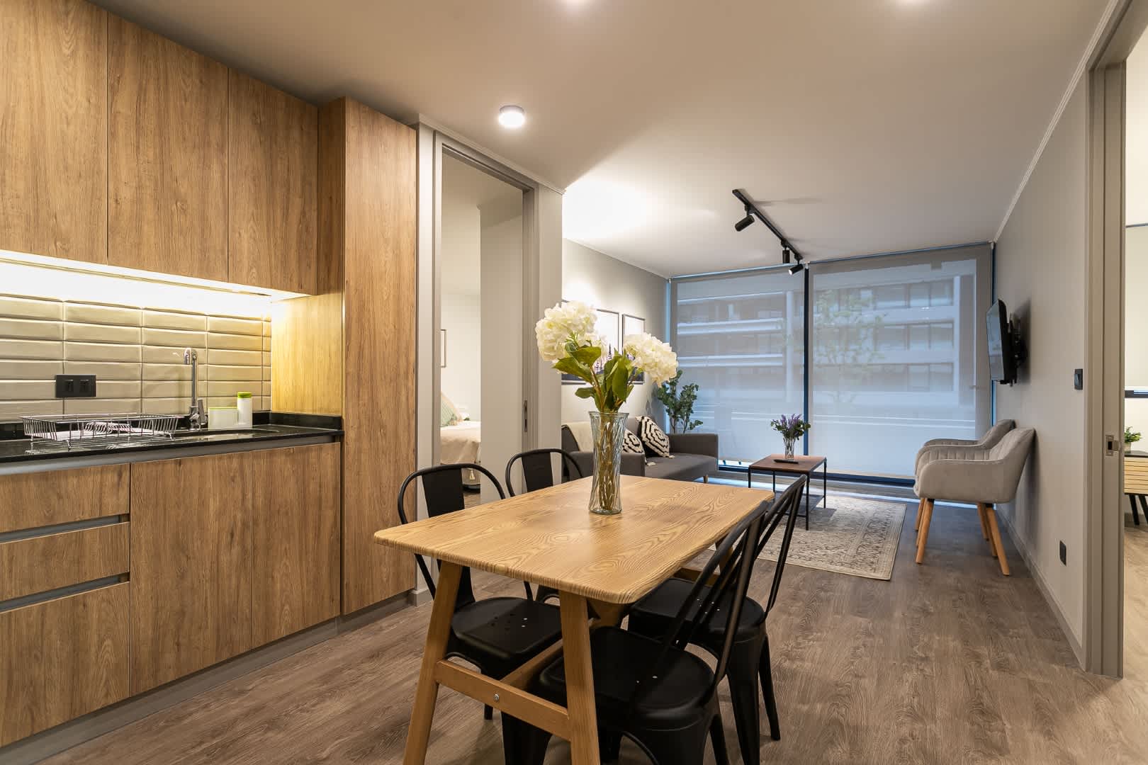 Experience modern comfort in this stylish open-plan kitchen and living area, perfect for relaxing and dining.
