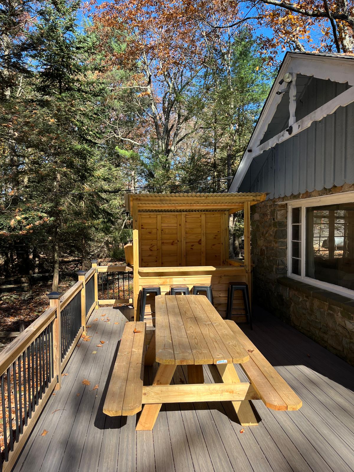 Outdoor Dining & Bar Area
Enjoy meals in the fresh mountain air with this cozy picnic table setup, complete with a charming wooden bar perfect for entertaining or enjoying morning coffee in nature.