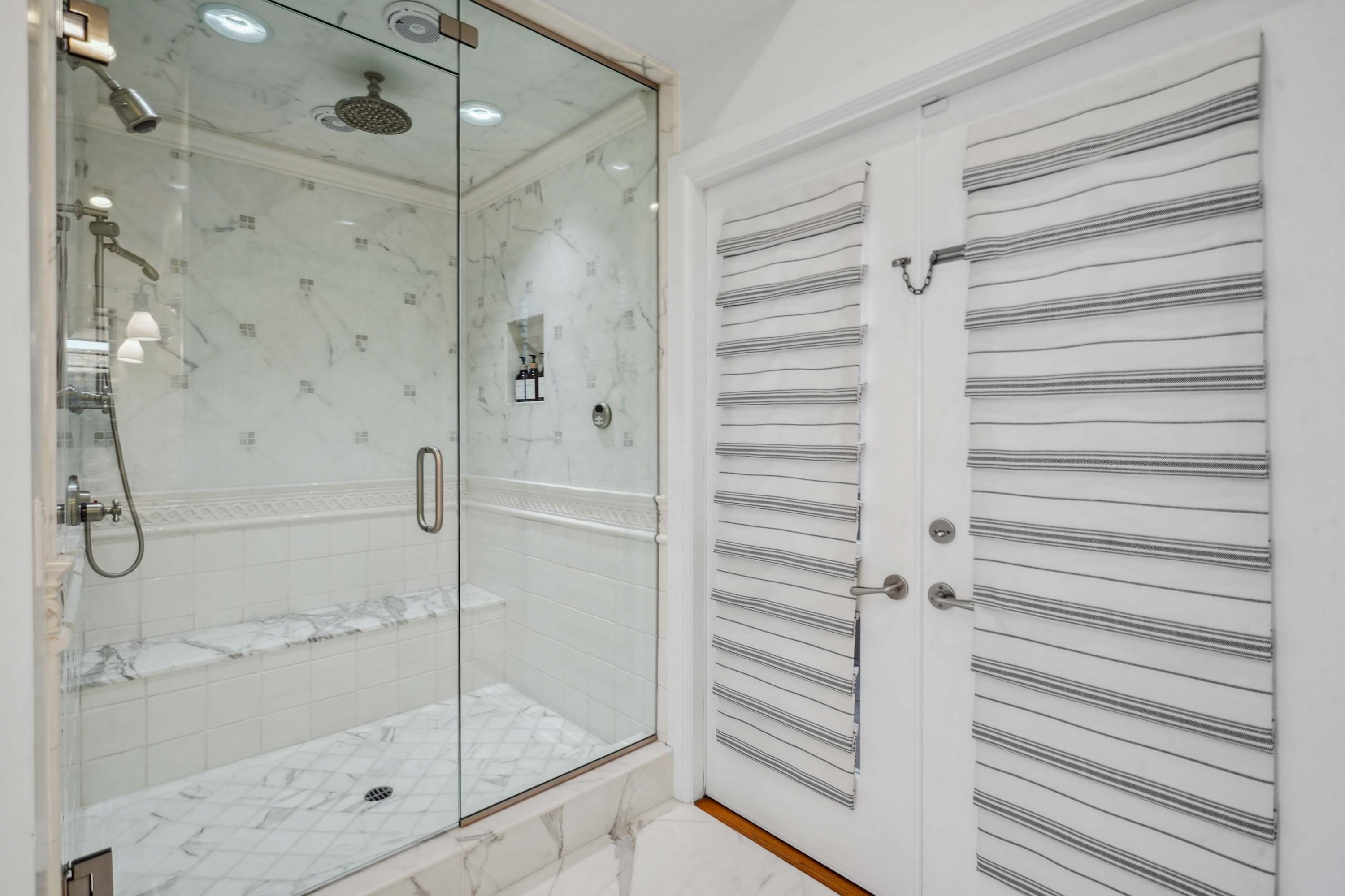 Chrome rain showerhead and fixtures offer a spa-like experience.