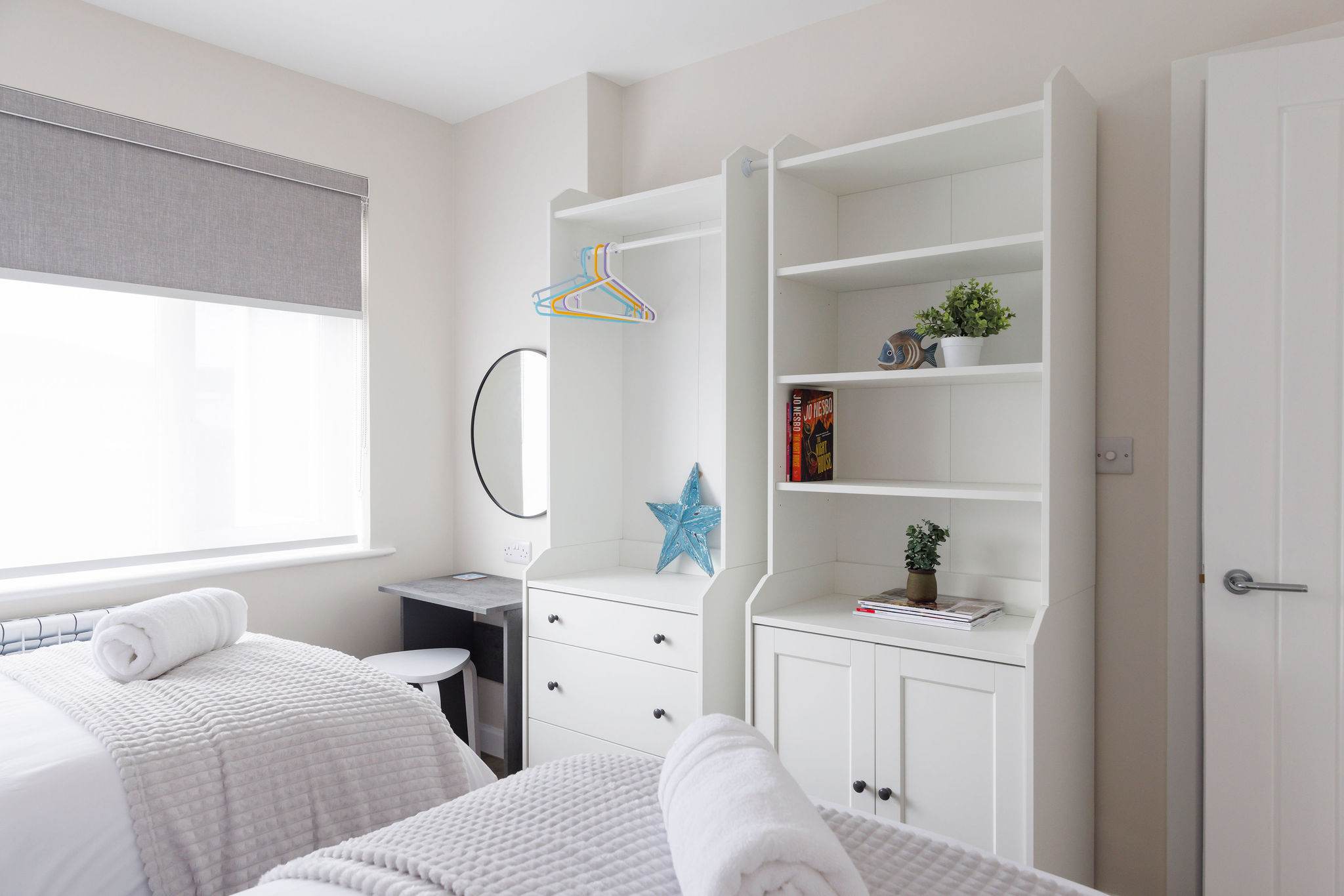 This room has lots of storage space and a small vanity desk.
