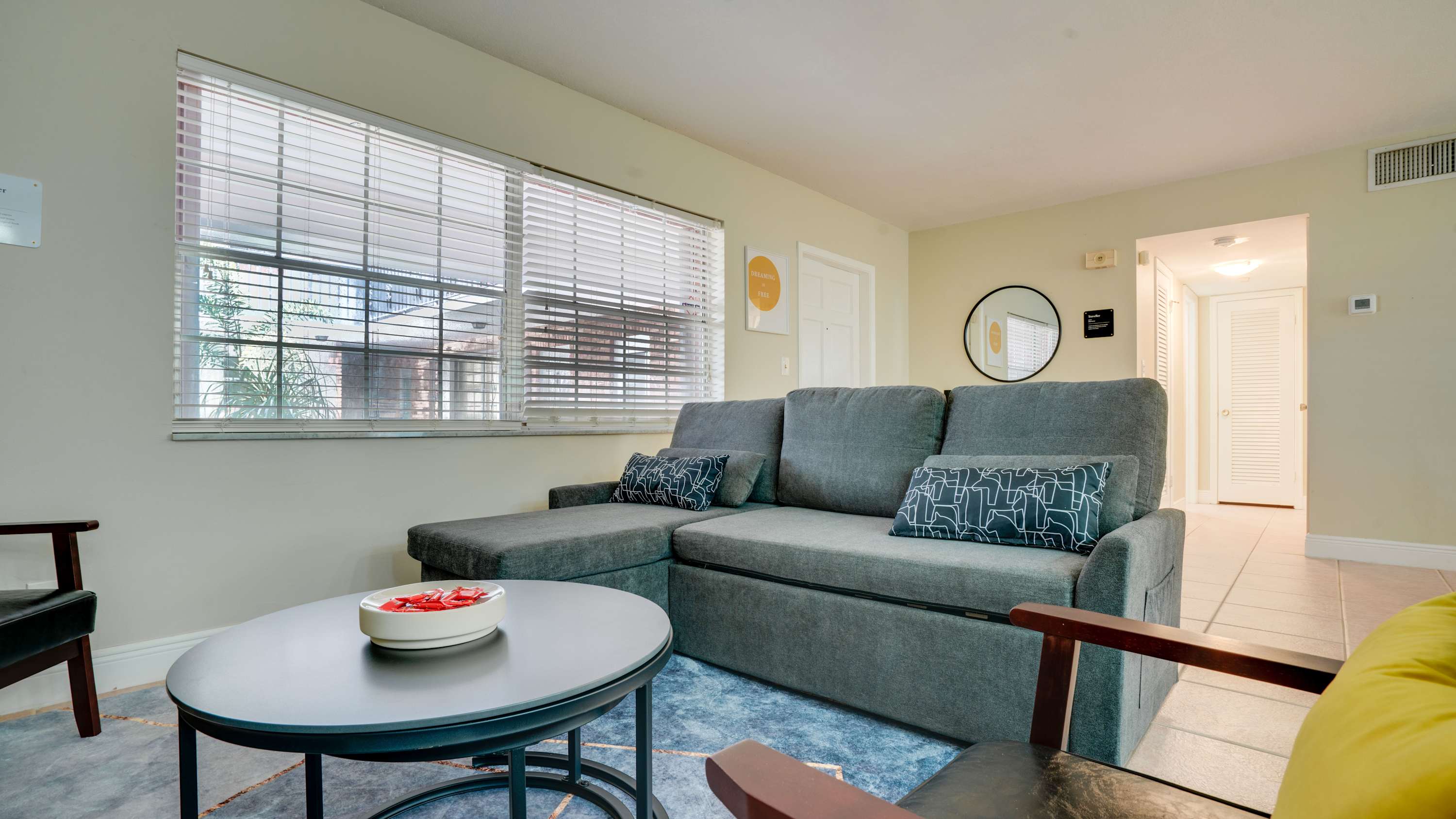 Cozy living room with a comfy sectional sofa and ample natural light, perfect for relaxation.