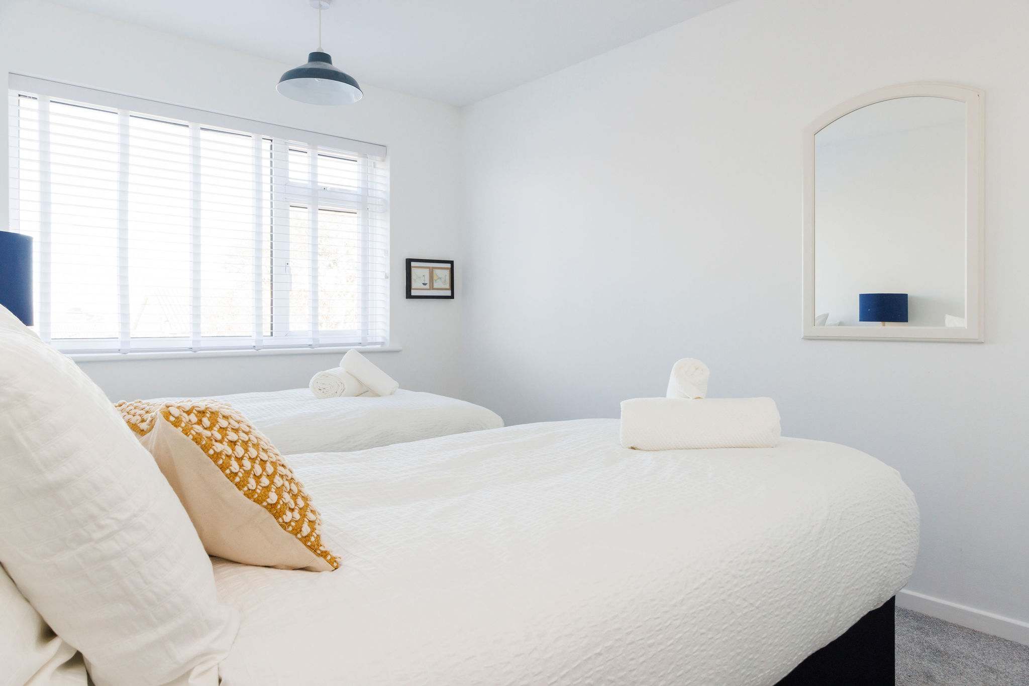 Cozy twin room with soft, inviting bedding.