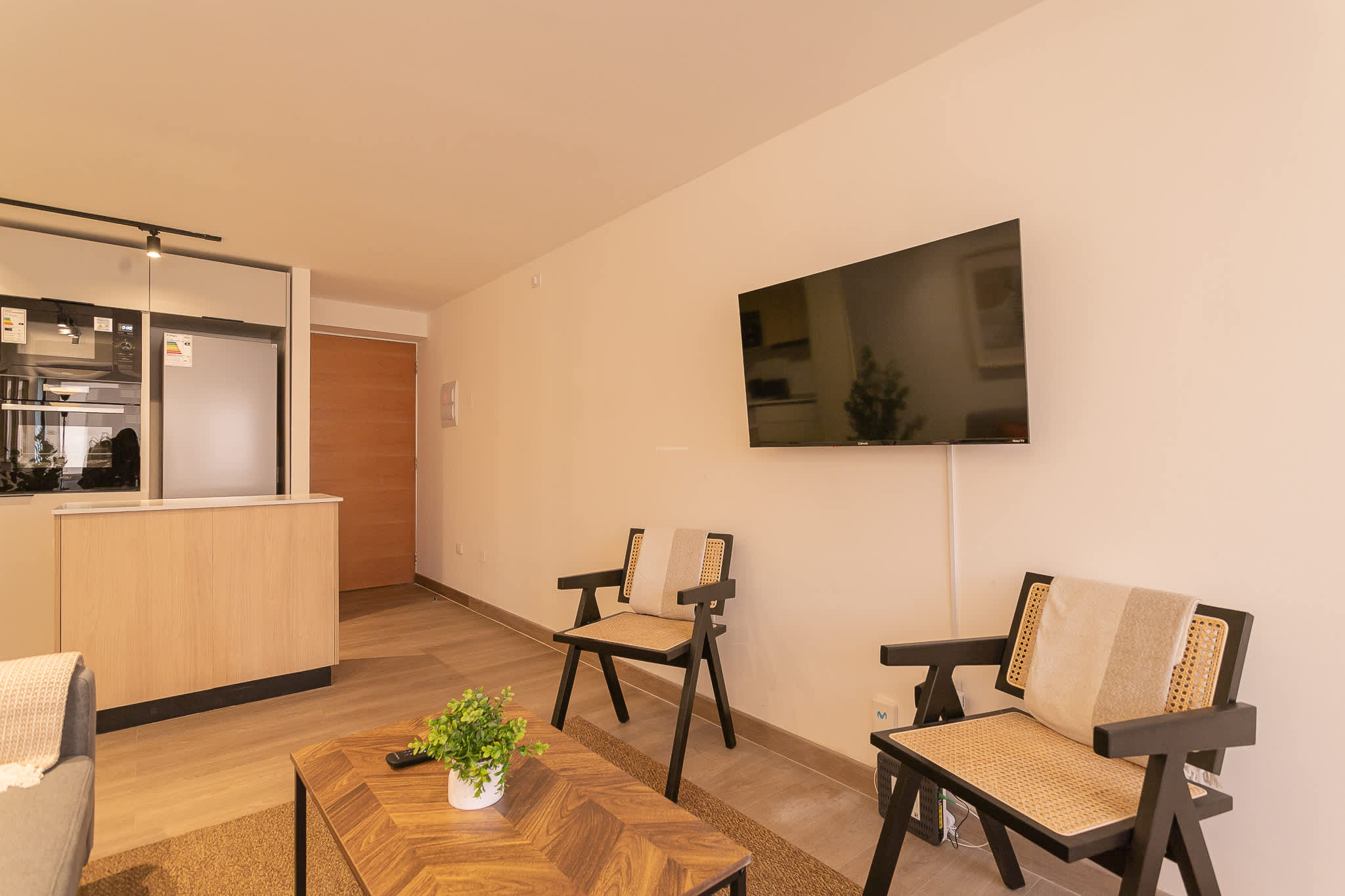 Relax in this modern living room with sleek furnishings and a cozy atmosphere, perfect for unwinding after a day of exploring.