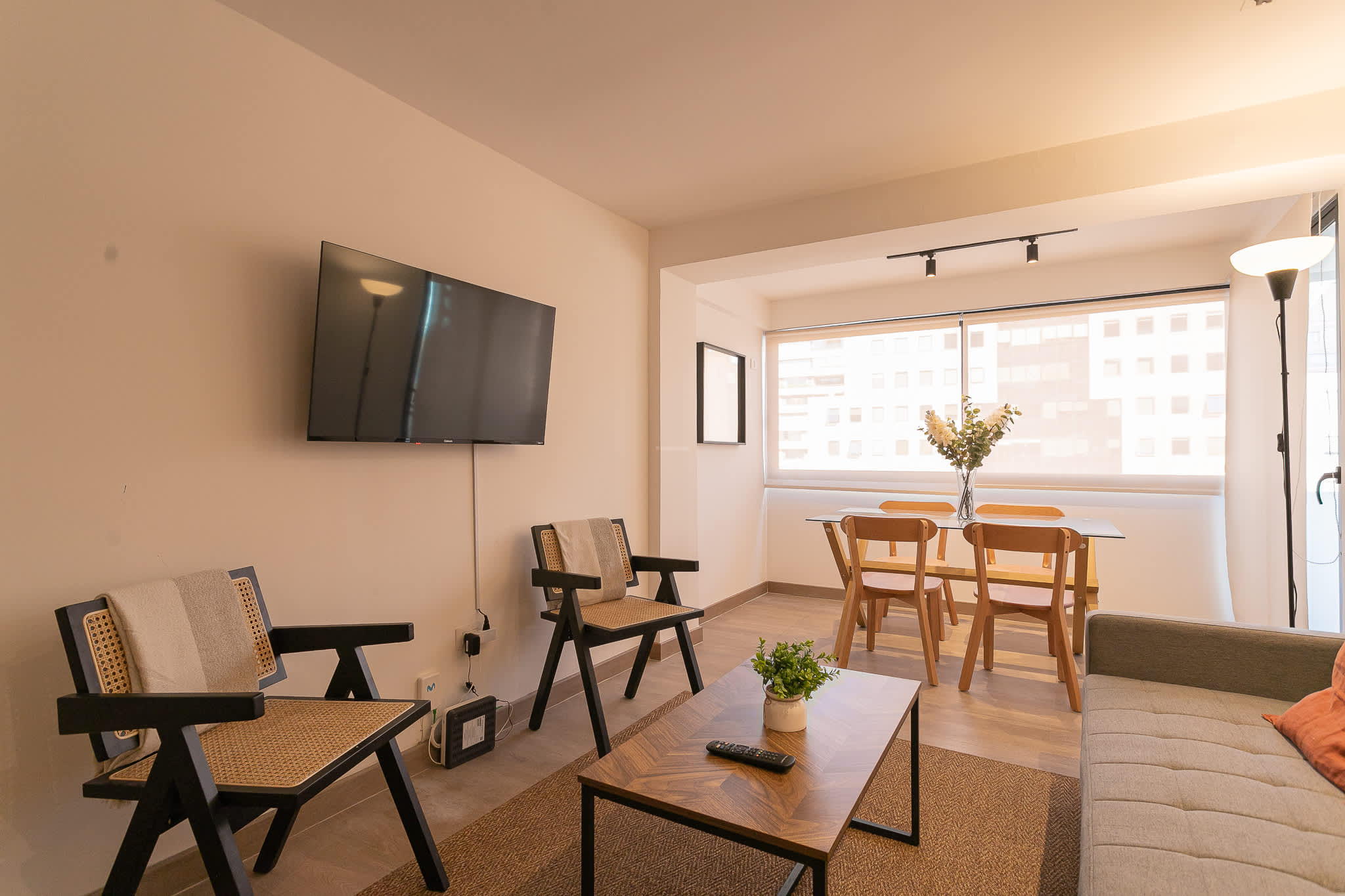 Bright and modern living space with a cozy dining area, perfect for relaxation and entertaining.