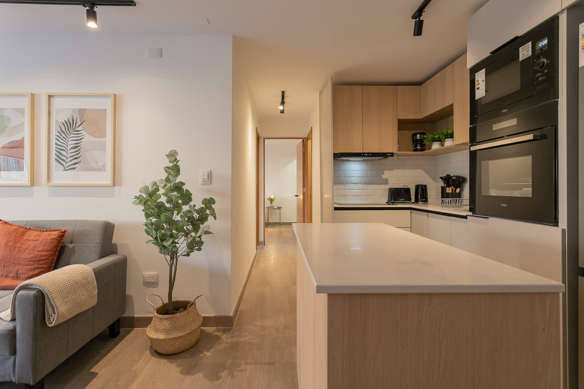 Experience modern comfort in this stylish kitchen and living area, perfect for relaxing or entertaining.