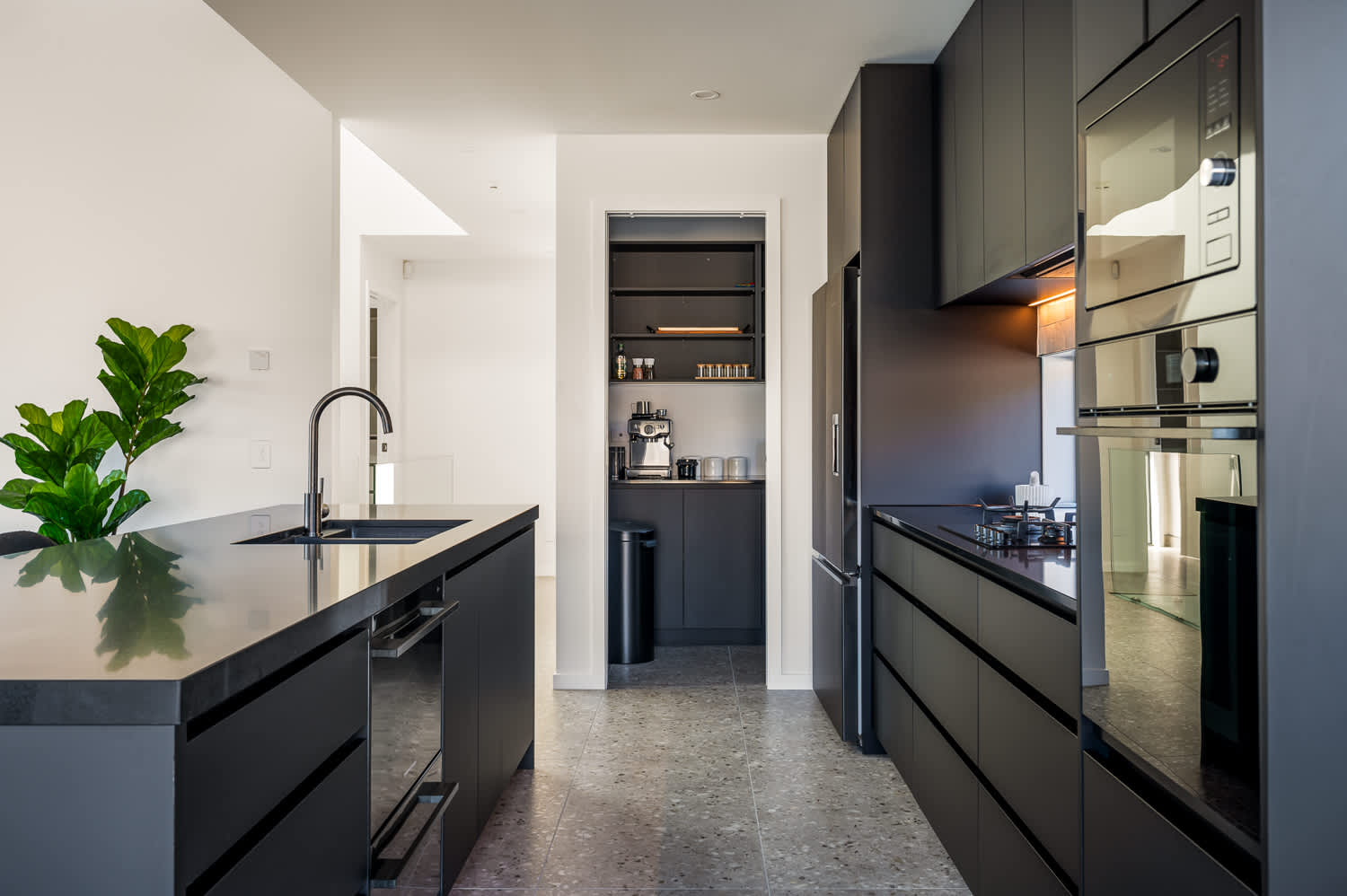 The open-plan layout seamlessly connects the kitchen to the dining and living areas, creating an inviting atmosphere for hosting guests or enjoying family meals. 
